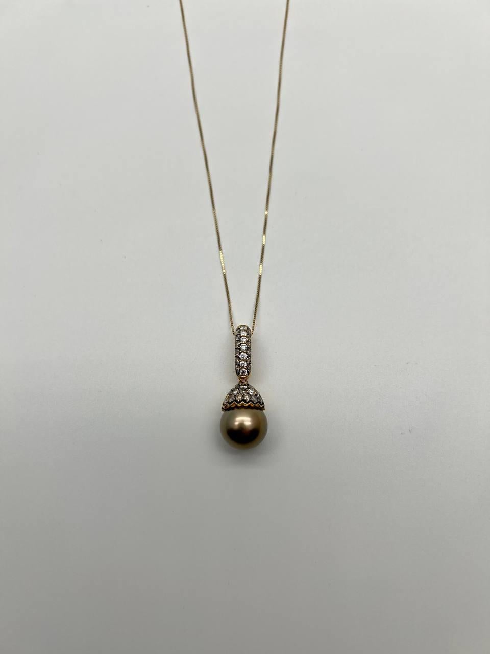 Elegant pendant necklace featuring a lustrous dark brown pearl. The pendant is adorned with a row of sparkling diamonds, adding a touch of sophistication. The pearl is set in a detailed cap, enhancing its natural beauty. The chain is delicate and