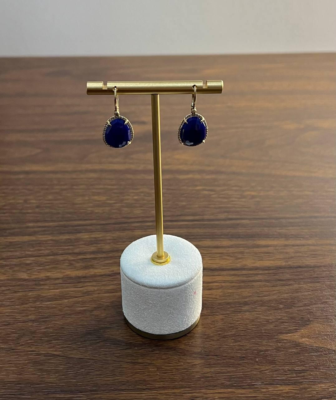 A pair of striking earrings featuring deep blue azurite surrounded by delicate diamonds, set in 14k gold.

Primary Carat Weight: 11.75 ctw (14.5x12X4.5 MM Size)
Secondary Stone: Diamond
Secondary Carat Weight: 0.25 ctw