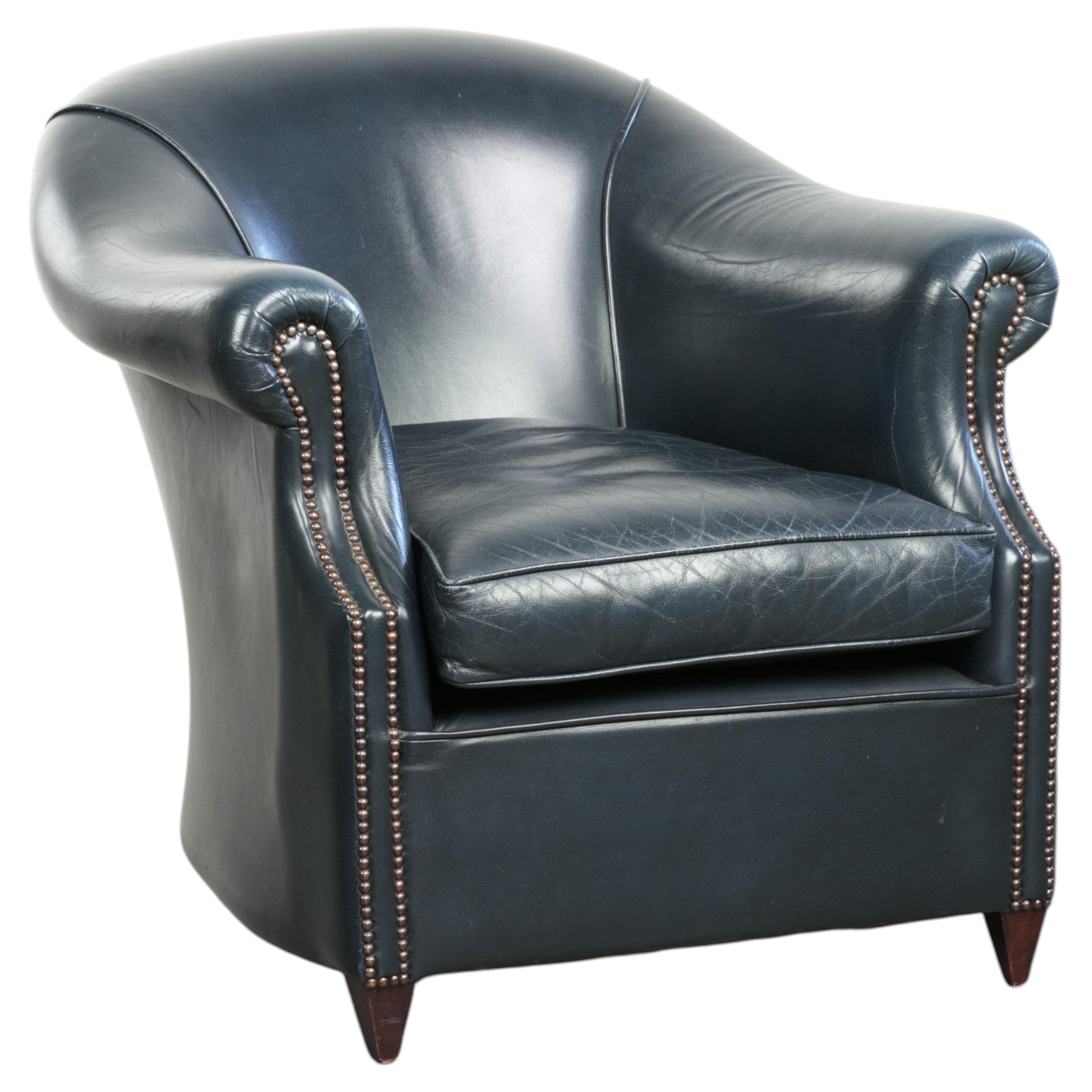 Dark blue cowhide club armchair with a unique and timeless design