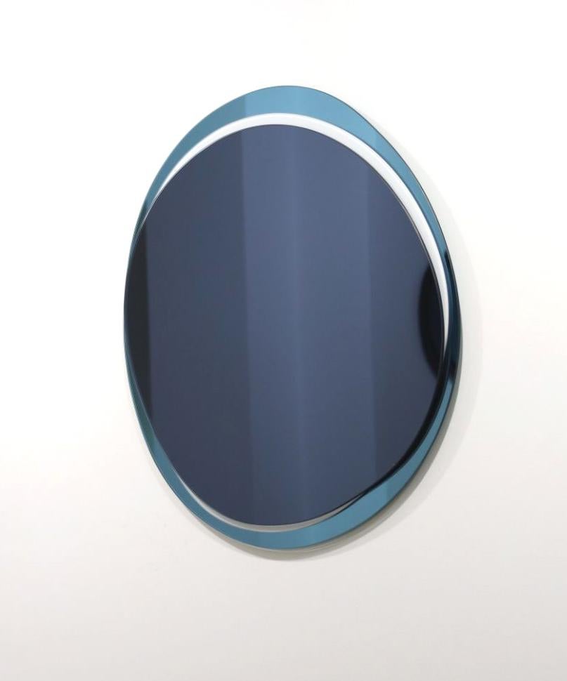 Dark blue eclipse medium hand-sculpted mirror, Laurene Guarneri
Limited edition.
Handmade.
Materials: Sky blue colored mirror, dark blue colored mirror, dark colored mirror.
Dimensions: 65 x 65 cm

Laurène Guarneri is a designer based in