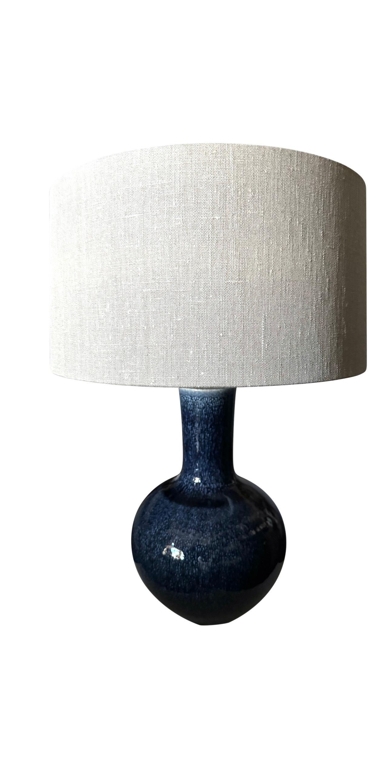 Contemporary Chinese pair dark blue glazed lamps.
Funnel neck shape.
Belgian linen shades included.
Shade diameter 16