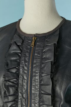 The dark blue leather jacket with leather and tulle ruffle on the front REDValentino