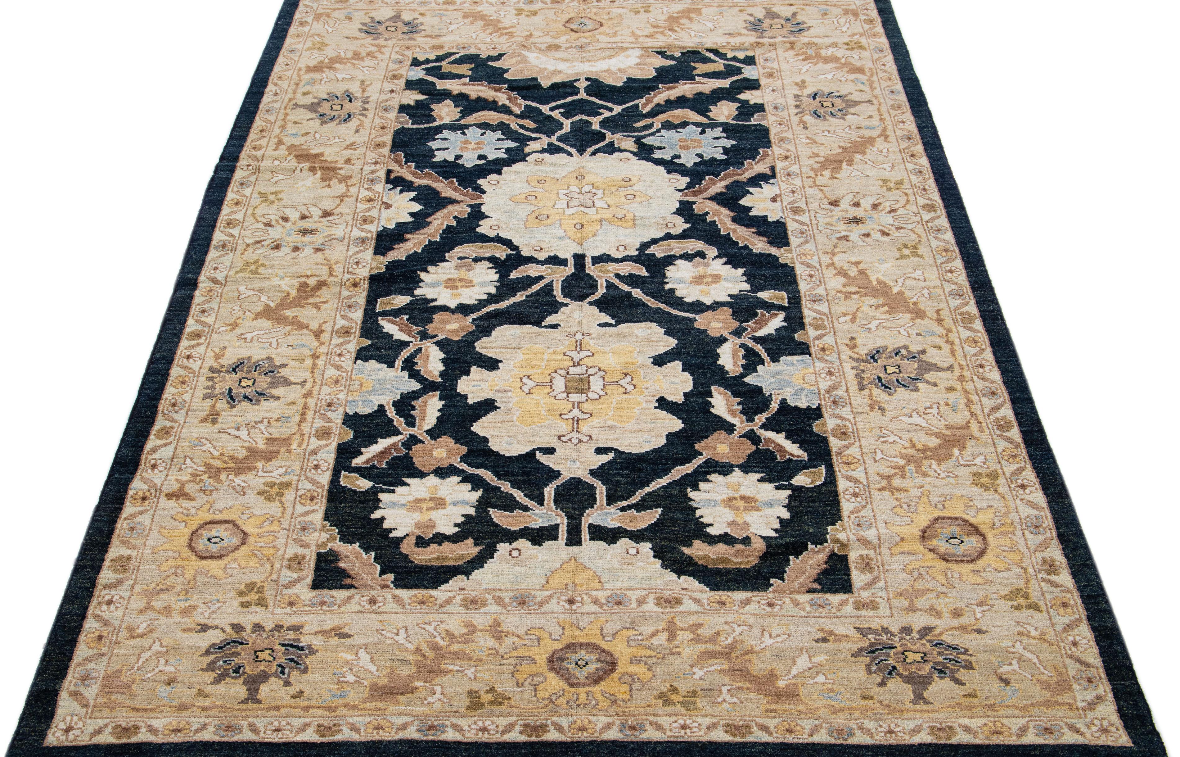 Beautiful modern Sultanabad hand-knotted wool rug with a dark blue color field. This rug has a designed frame with tan, brown, and blue accents in a gorgeous all-over floral design.

This rug measures: 6'8