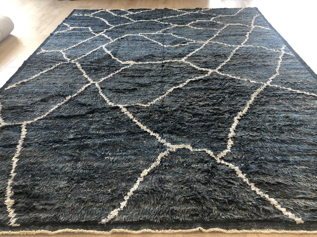 Thick dark navy shag pile and an eye-catching ivory web pattern make this rug both lovely to look at and luxurious underfoot. Hand crafted wool, made in India from Moroccan design. All-natural vegetal dyes.