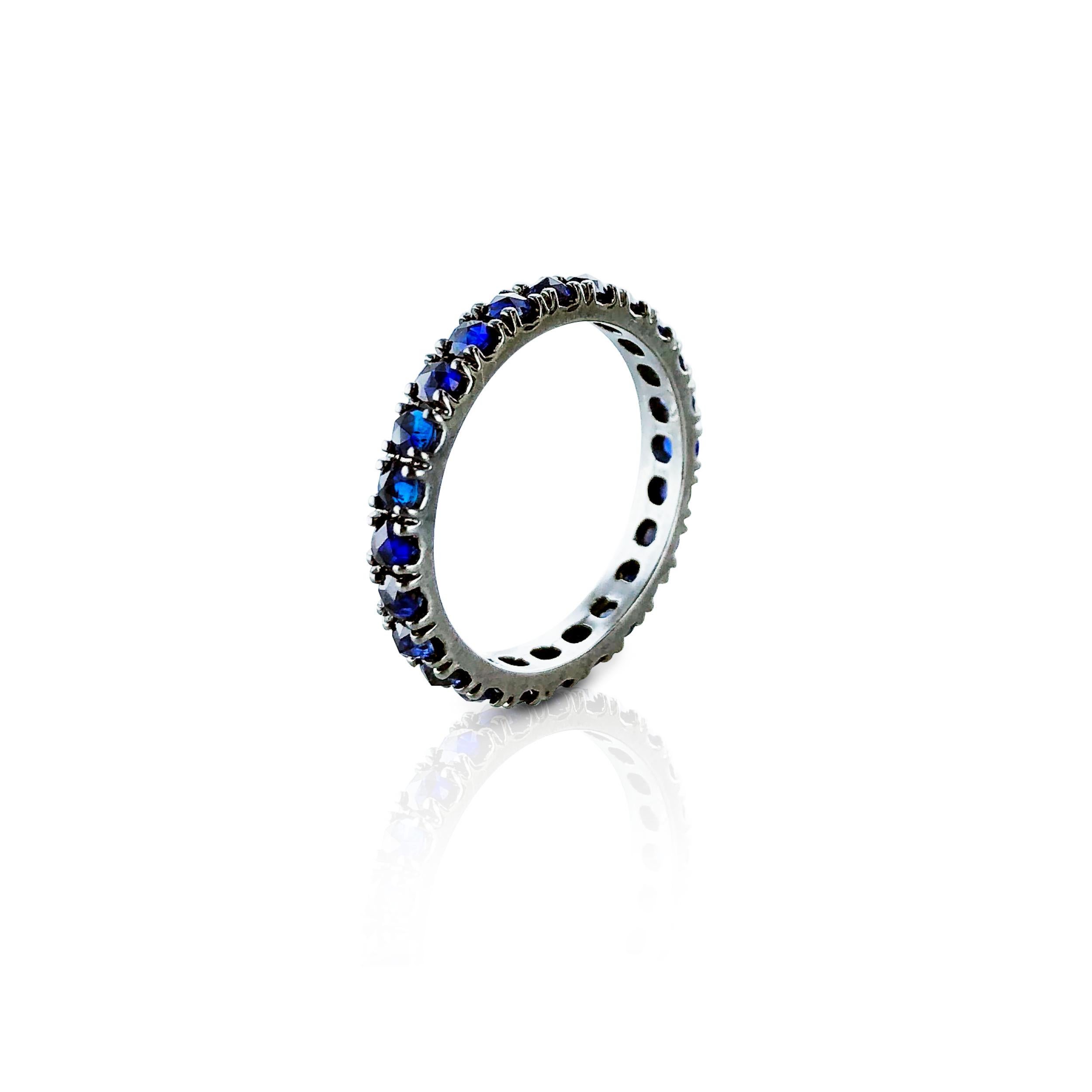 This dark blue sapphire 1.60 Carat eternity ring is set in 18kt black Gold.
Unisex it looks fabulous on any finger, worn alone or stacked with other rings. 

Designed and Certified by Amin Luxury, it is made in Italy. 

Blue Sapphire Carats         