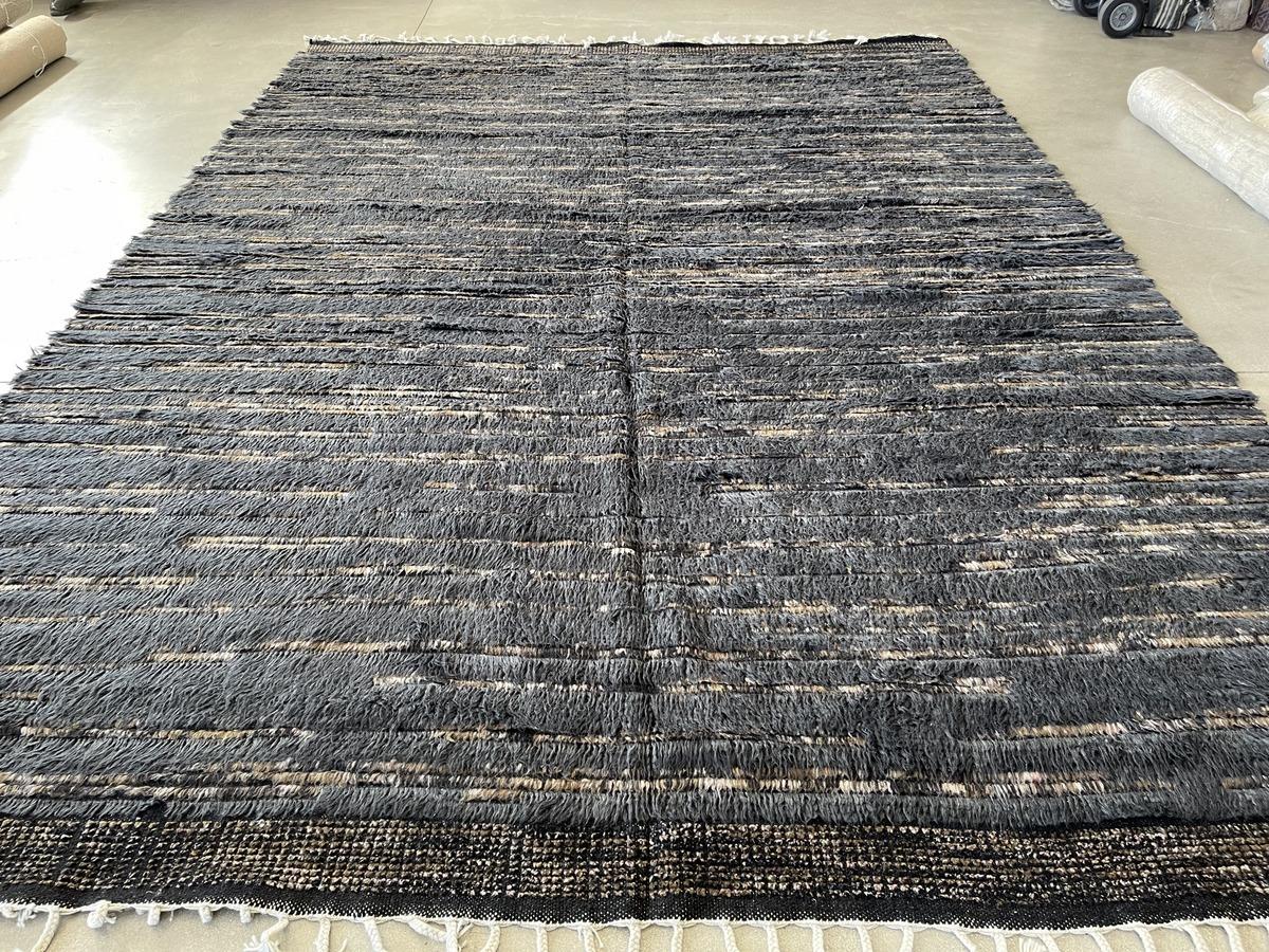 Thick rich dark blue shag against a woven background that will add both texture and visual interest to any room. Wool with natural dyes. Also available in 10' x 14'.