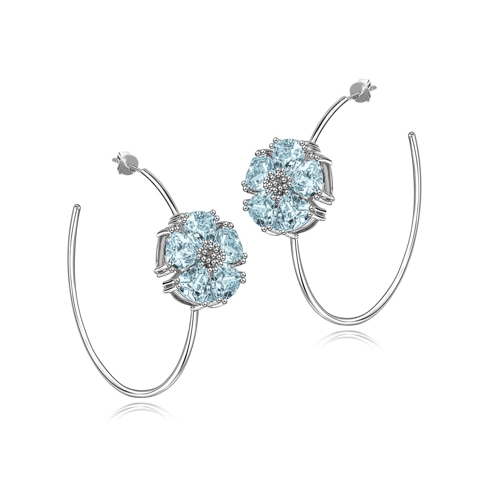 Designed in NYC

.925 Sterling Silver 2 x 20 mm Dark Blue Topaz Blossom Stone Open Hoops. No matter the season, allow natural beauty to surround you wherever you go. Blossom stone open hoops: 

Sterling silver 
High-polish finish 
Light-weight 
2 x