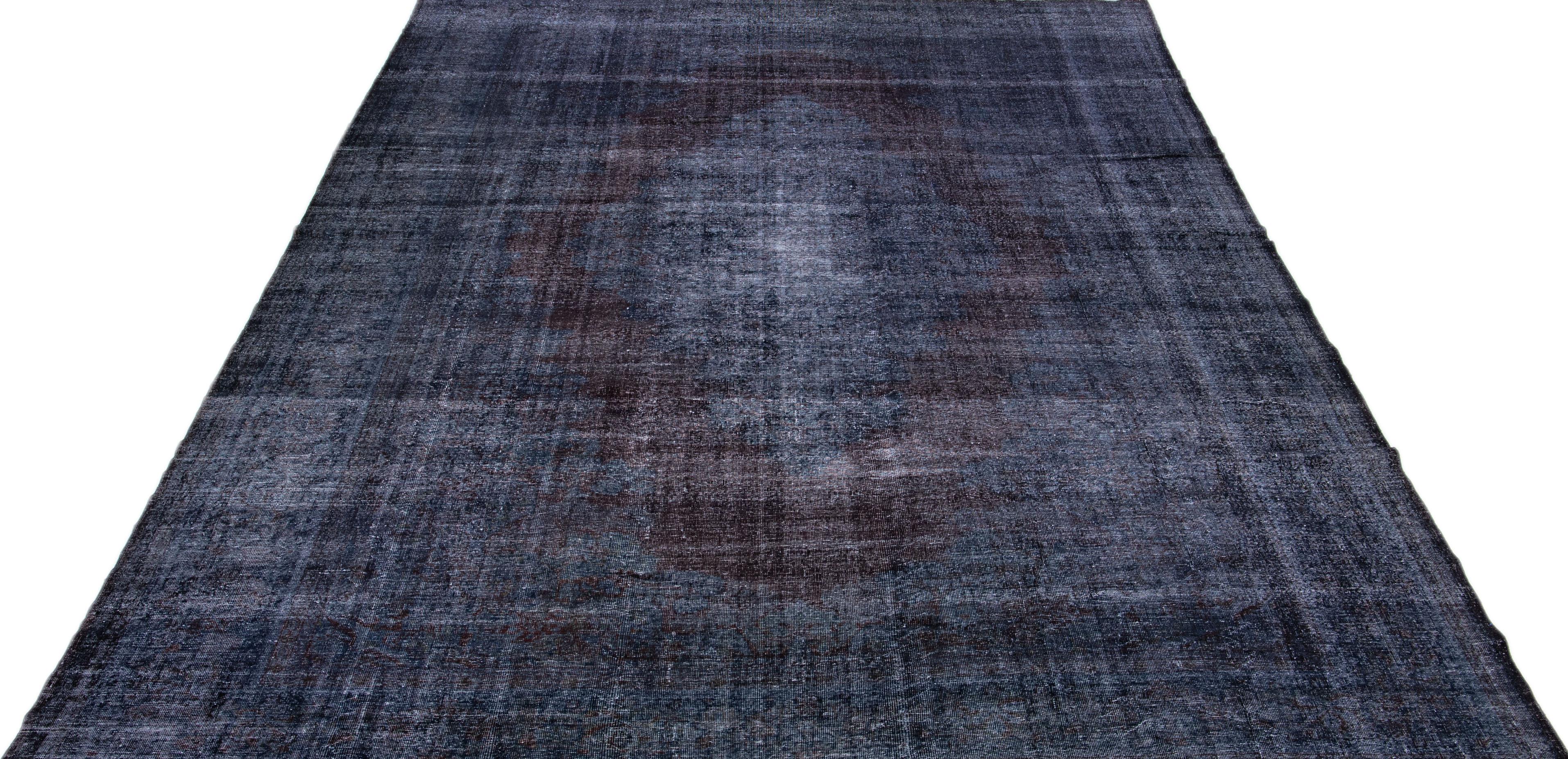 Beautiful Vintage Overdyed hand-knotted wool rug with a dark blue color field. This Turkish rug has brown accents in a gorgeous medallion design.

This rug measures: 11' x 16'8