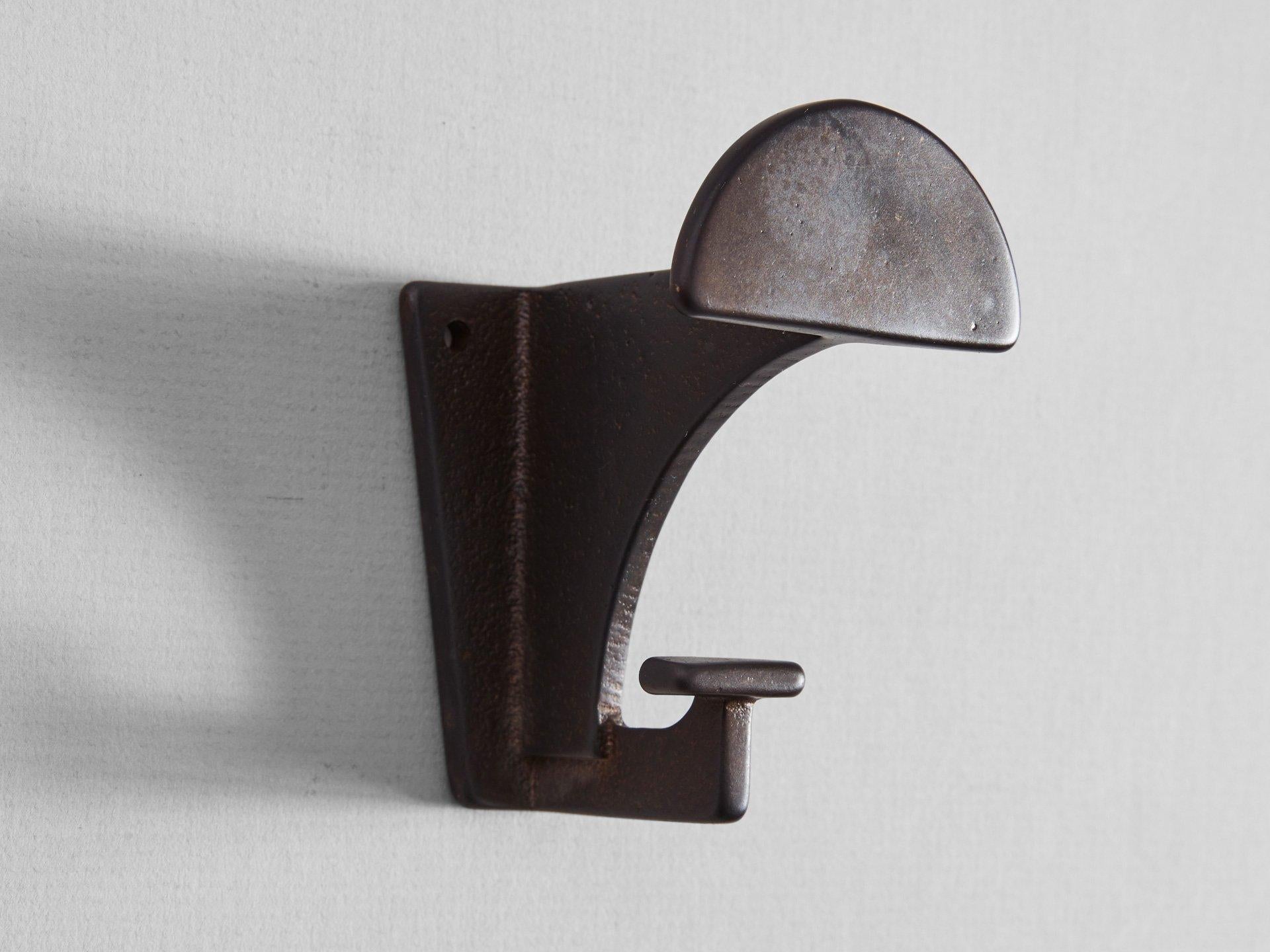 Dark bronze contemporary hook by Henry Wilson
The blackened compass hook is made, finished and polished in Sydney, Australia using sand-casted gunmetal bronze. For its size, it can bear a surprisingly substantial heft.  

Sand-casting involves