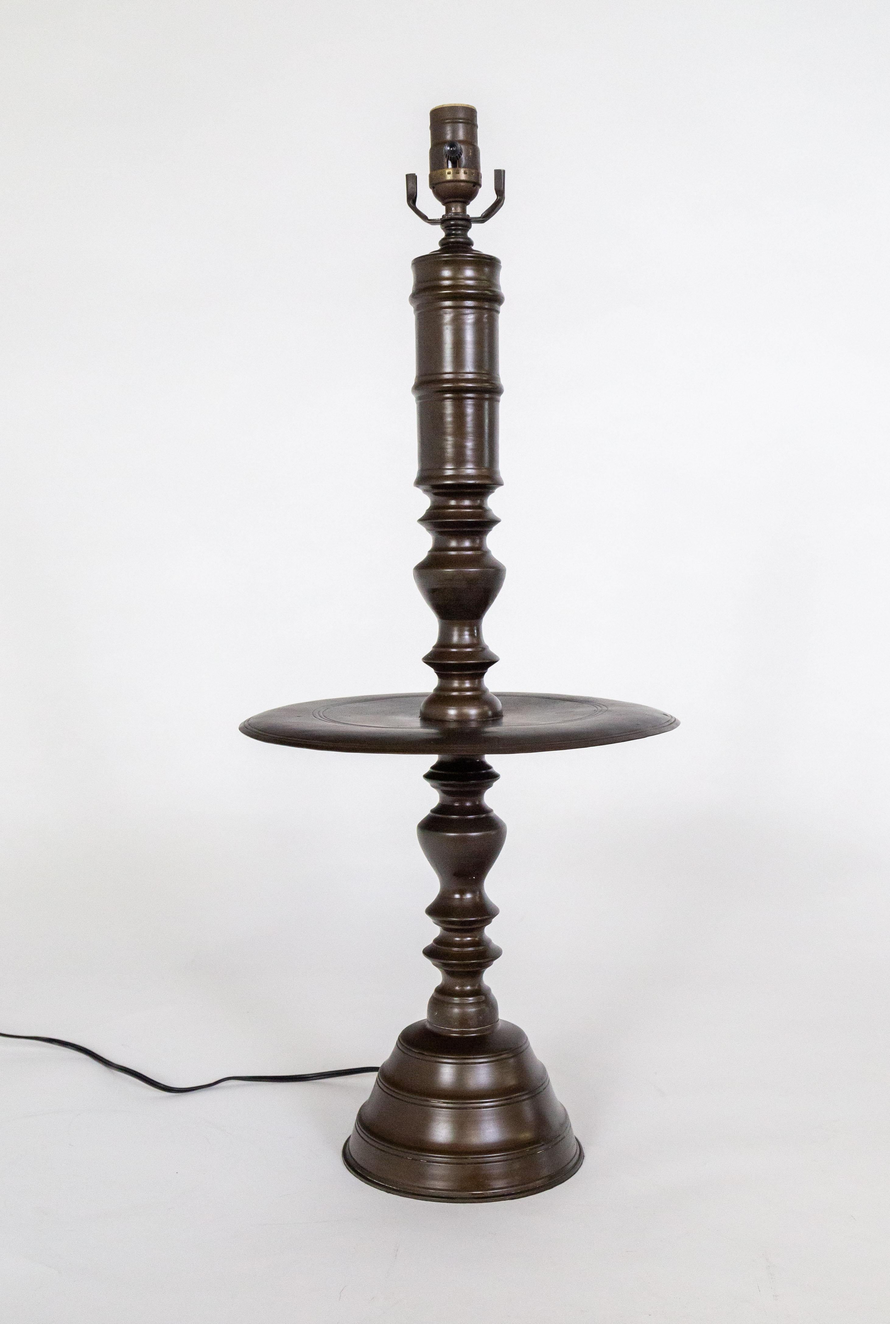 A Dutch Colonial lamp with a dish in the center of the turned-style, cast bronze body. It has a rich, dark, oil-rubbed bronze patina and balanced proportions. The center try can remain bare, but is large enough to be used to place various objects.