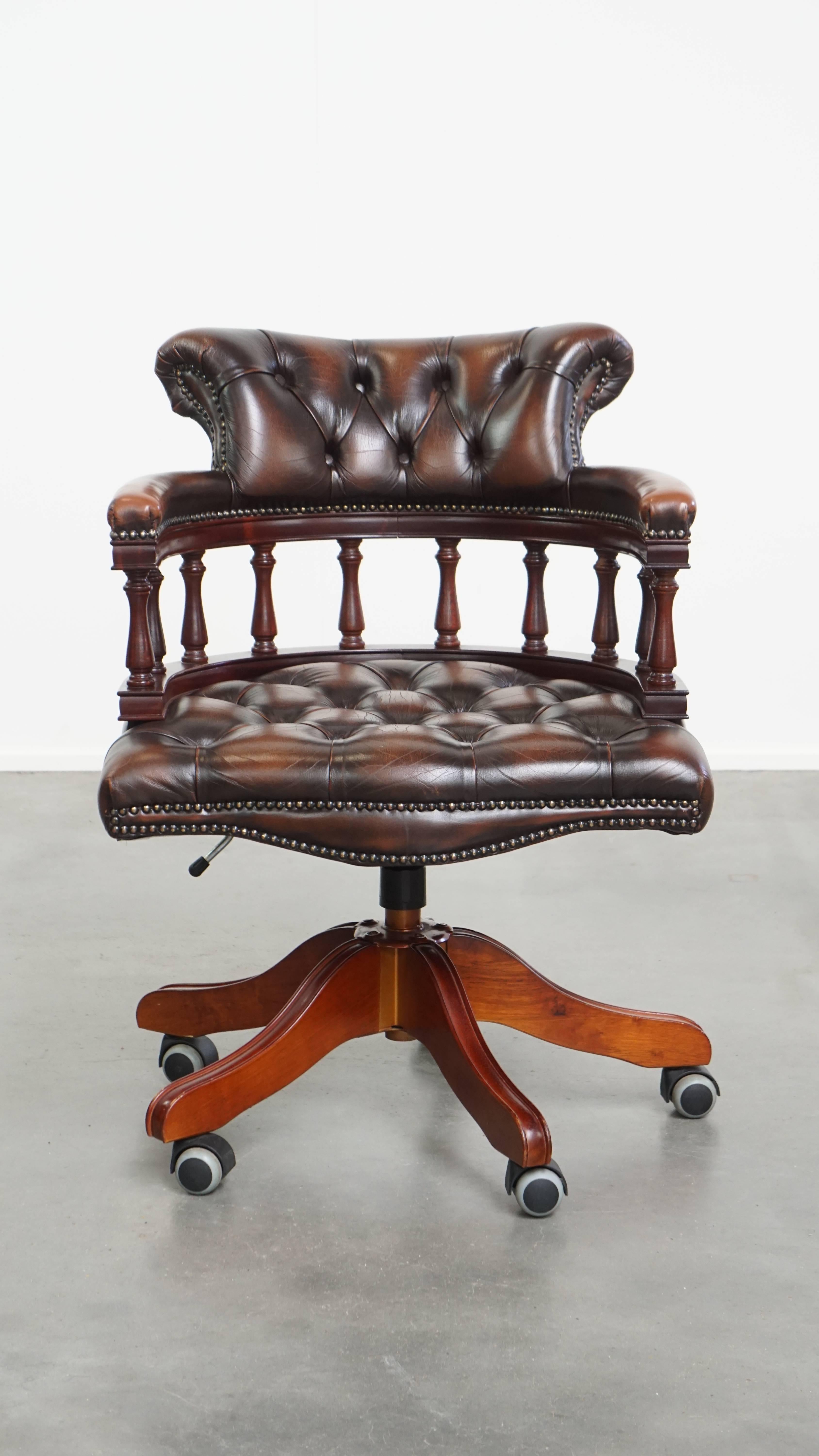 Offered here is this dark brown adjustable Chesterfield office chair made of cow leather and wood, featuring wheels, swivel and tilt functionality. This stylish and timeless office chair is a classic addition to any workspace.

The chair is