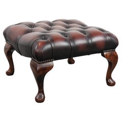 Dark brown chesterfield ottoman in cowhide leather