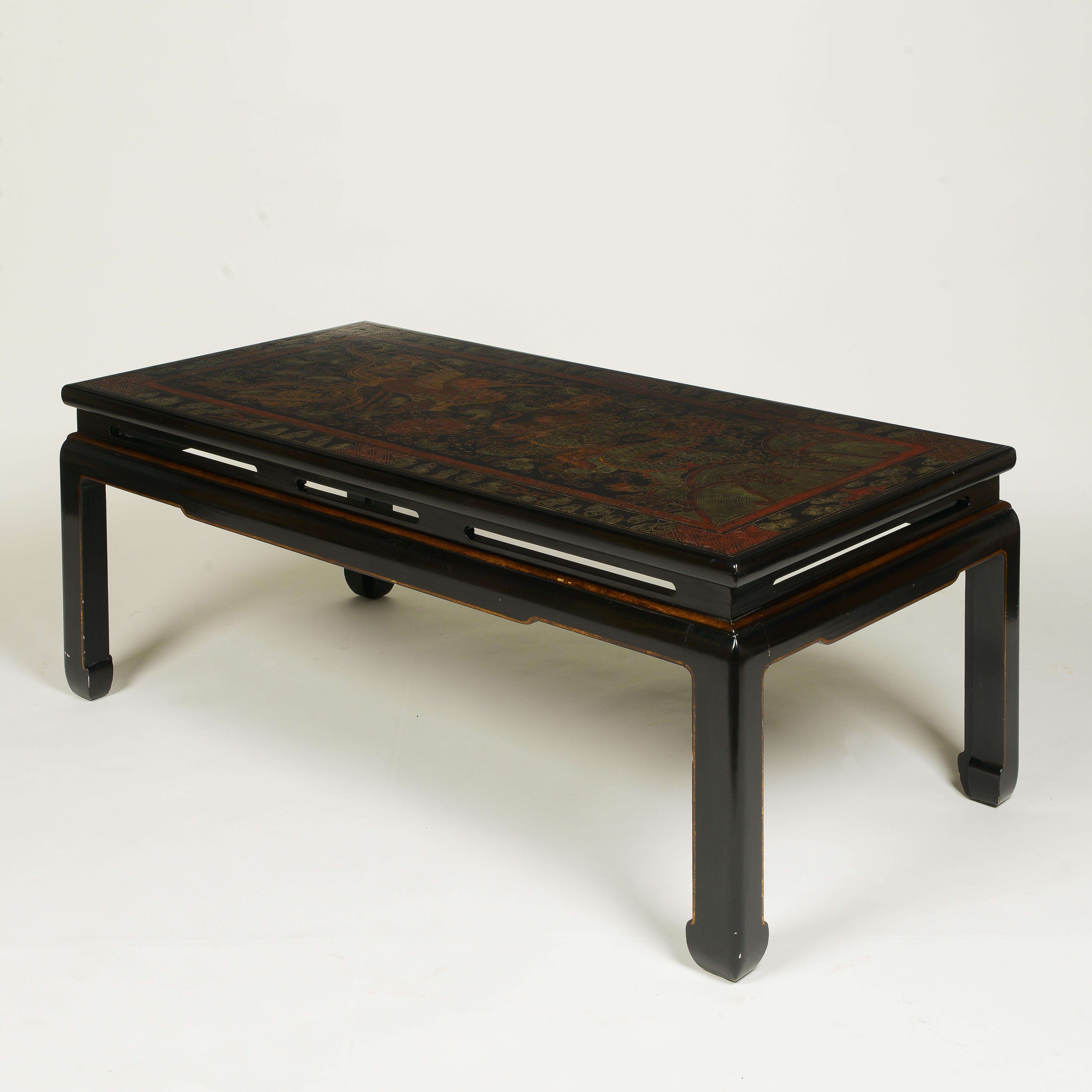 The rectangular top incised with dragon and phoenix chinoiserie decoration; raised on Ming-style legs.