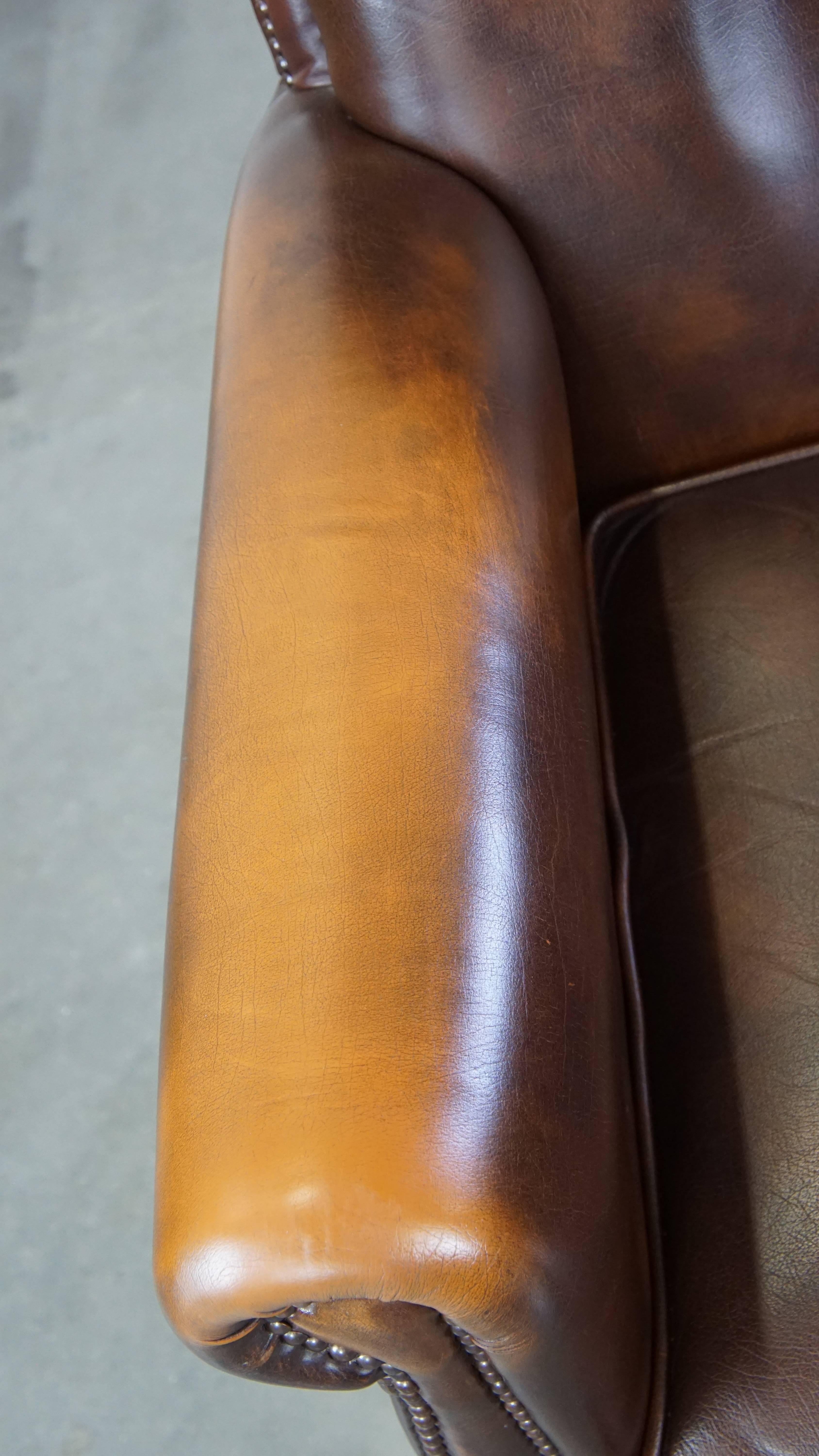 Dark brown cow leather English style armchair with a robust appearance For Sale 1