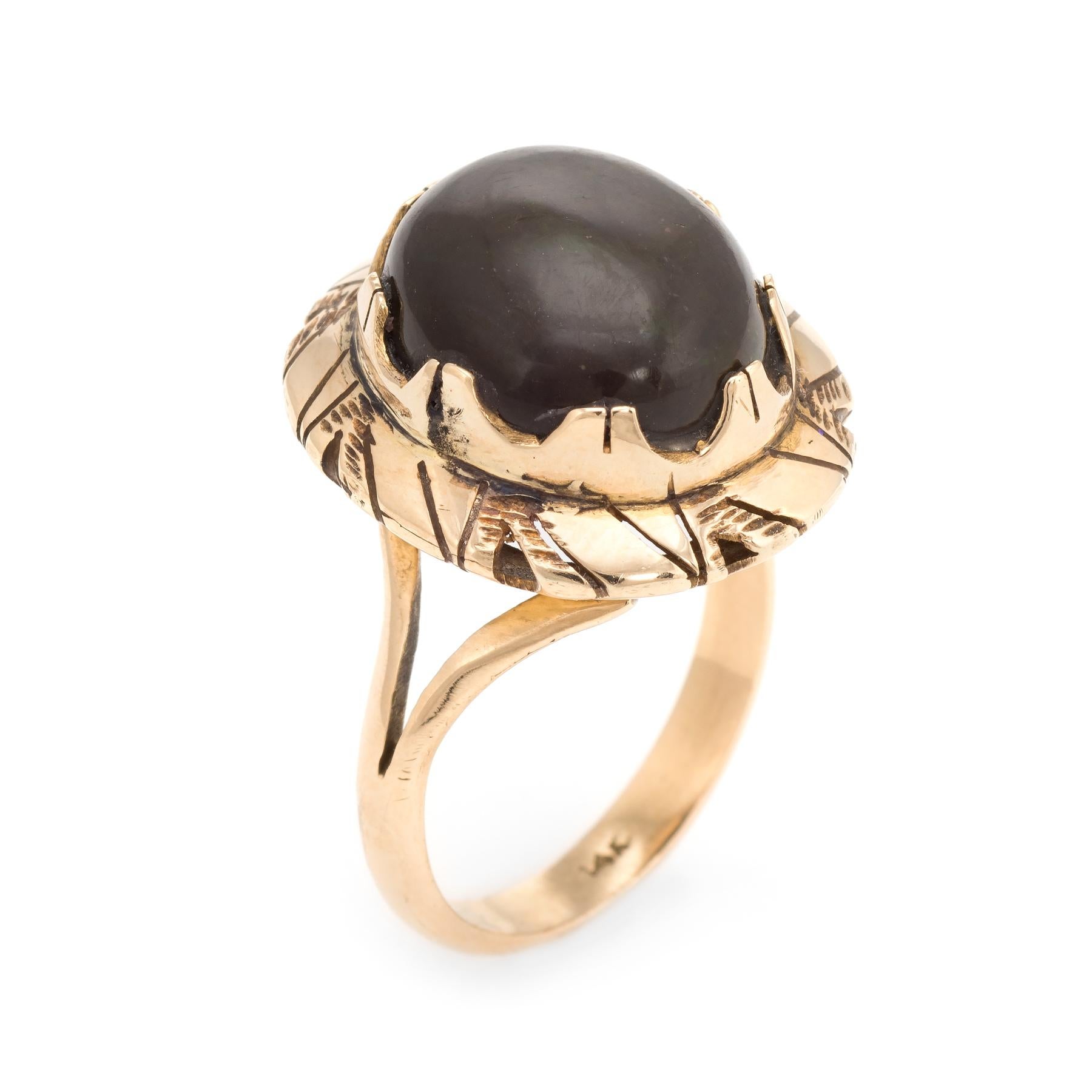 Stylish vintage dark brown opal coral ring (circa 1960s to 1970s) crafted in 14 karat yellow gold. 

Cabochon cut dark brown opal measures 15mm x 13mm (estimated at 9 carats). The opal is in excellent condition and free of cracks or chips. 

We