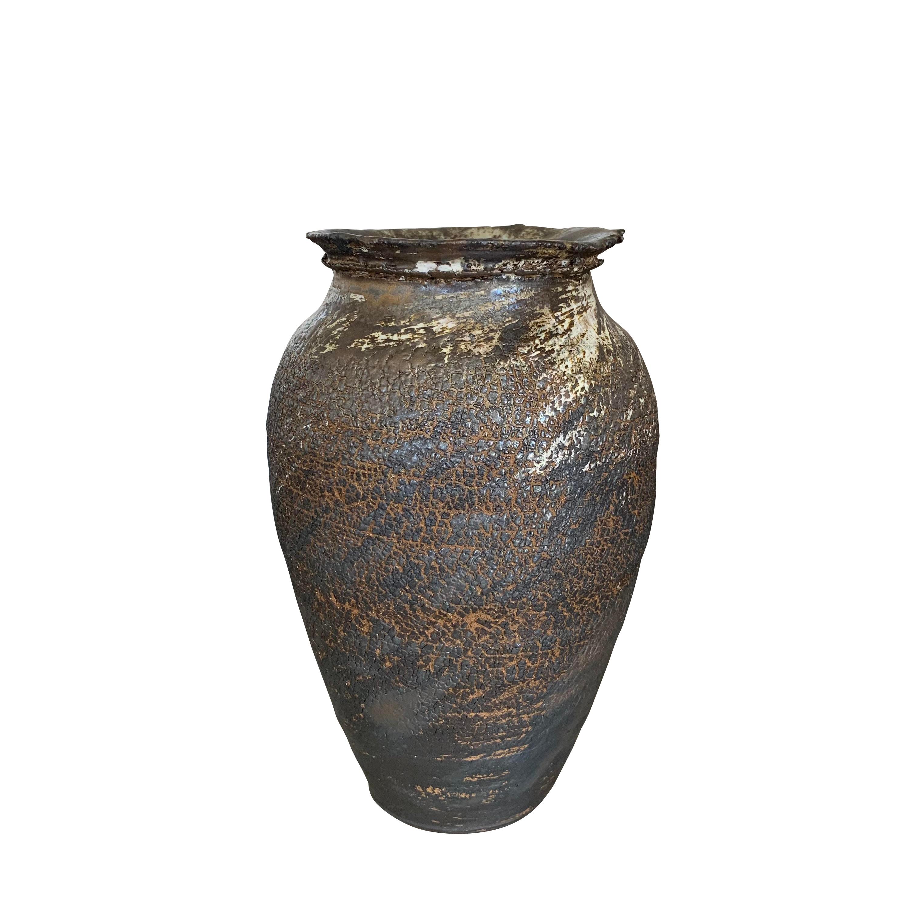 Contemporary American Ceramist Peter Speliopoulos stoneware vase.
The brown stoneware vessels are slipped in black and white, and then glazed with sweeping brushstrokes in various black, ivory and bronze glazes, to create an effect of erosion, as