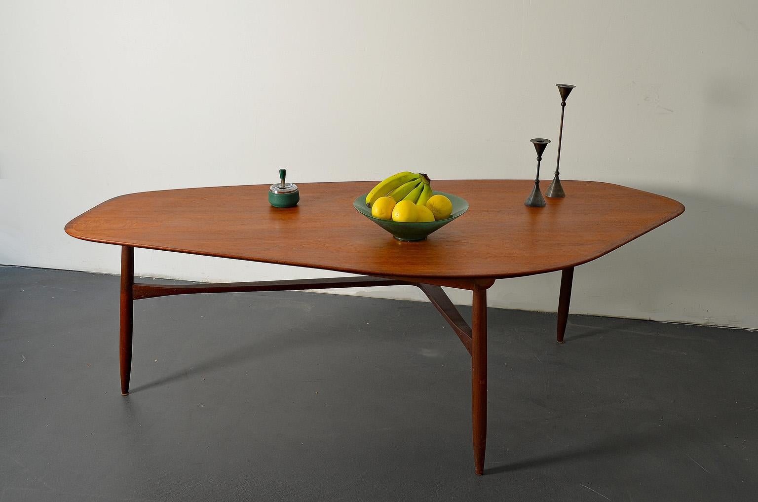 This dark, brown teak coffee table by Svante Skogh has been manufactured in 1953 in Sweden, Scandinavia.
The tabletop is designed in the shape of a kidney.
 