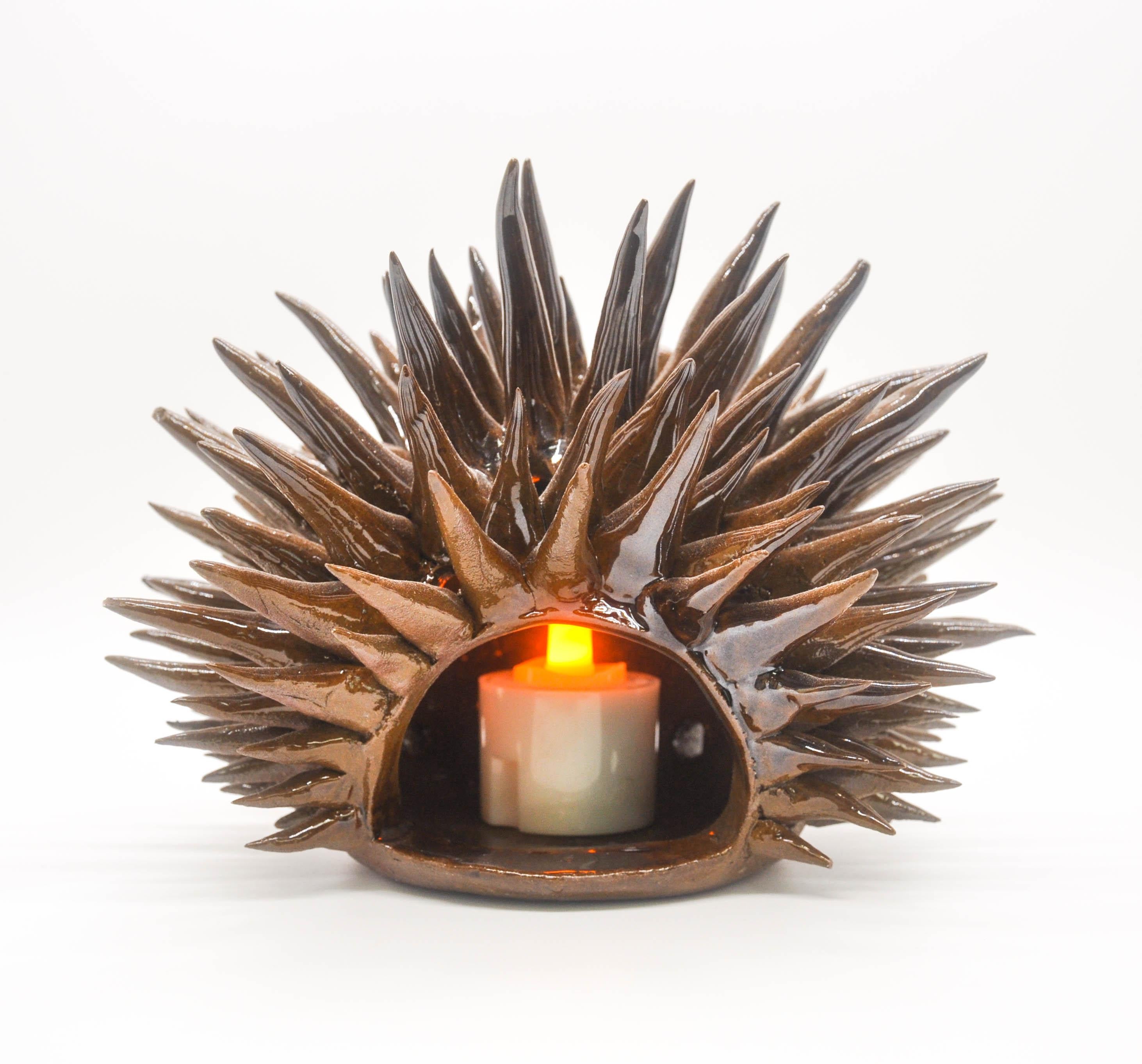 This whimsical candlelight Urchin is from our 2022 Urchin Collection. When lit, the hidden peepholes in its body allow light from within to shine through.

Each urchin is hand-sculpted with spikes that are individually rolled and attached, then