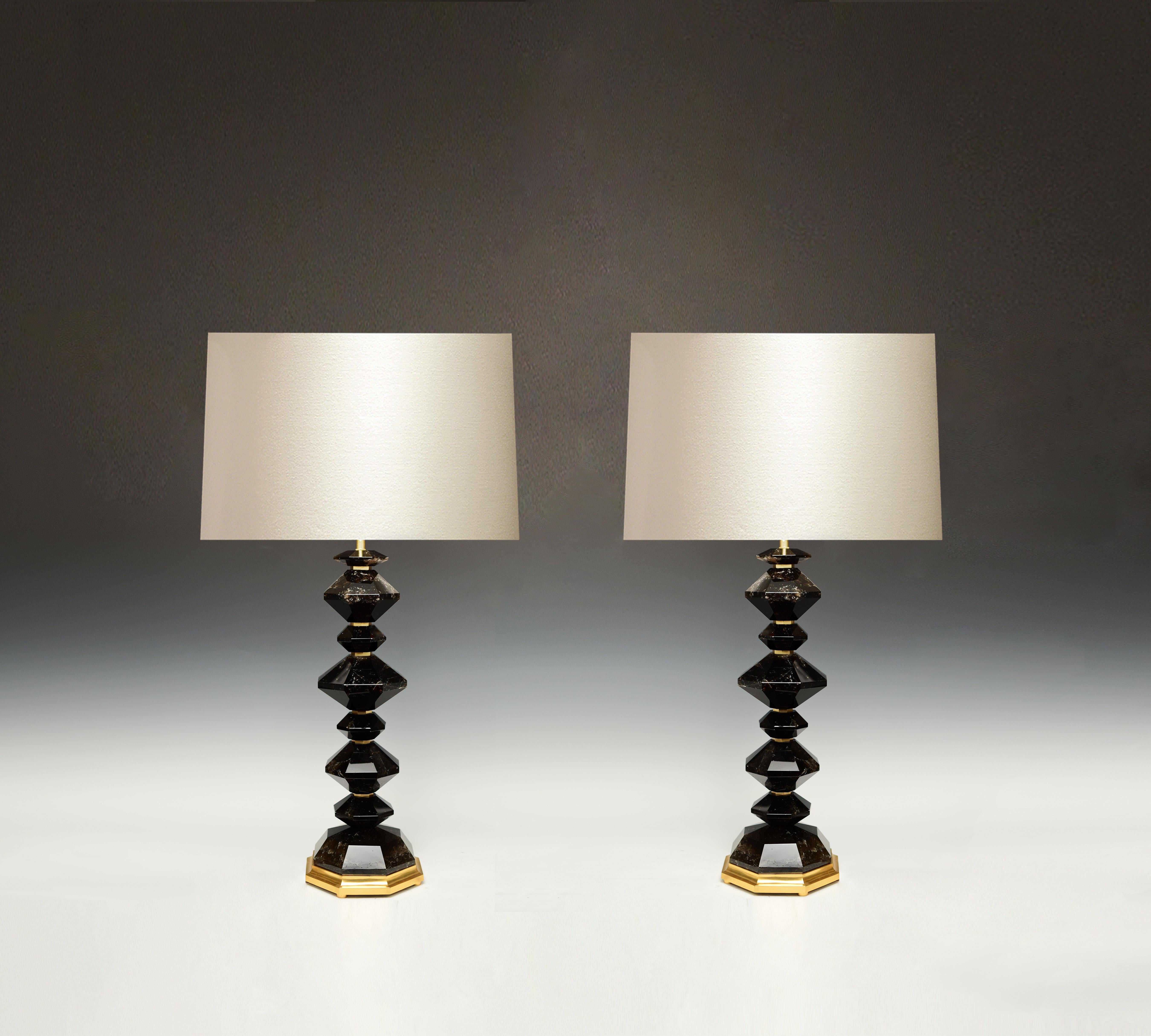 A pair of fine carved dark diamond rock crystal lamps with polish brass parts and bases, created by Phoenix Gallery, NYC.
Available in nickel plating and antique brass finished. 
To the rock crystal: 18.5 in/H.
(Lampshade not included). 
 