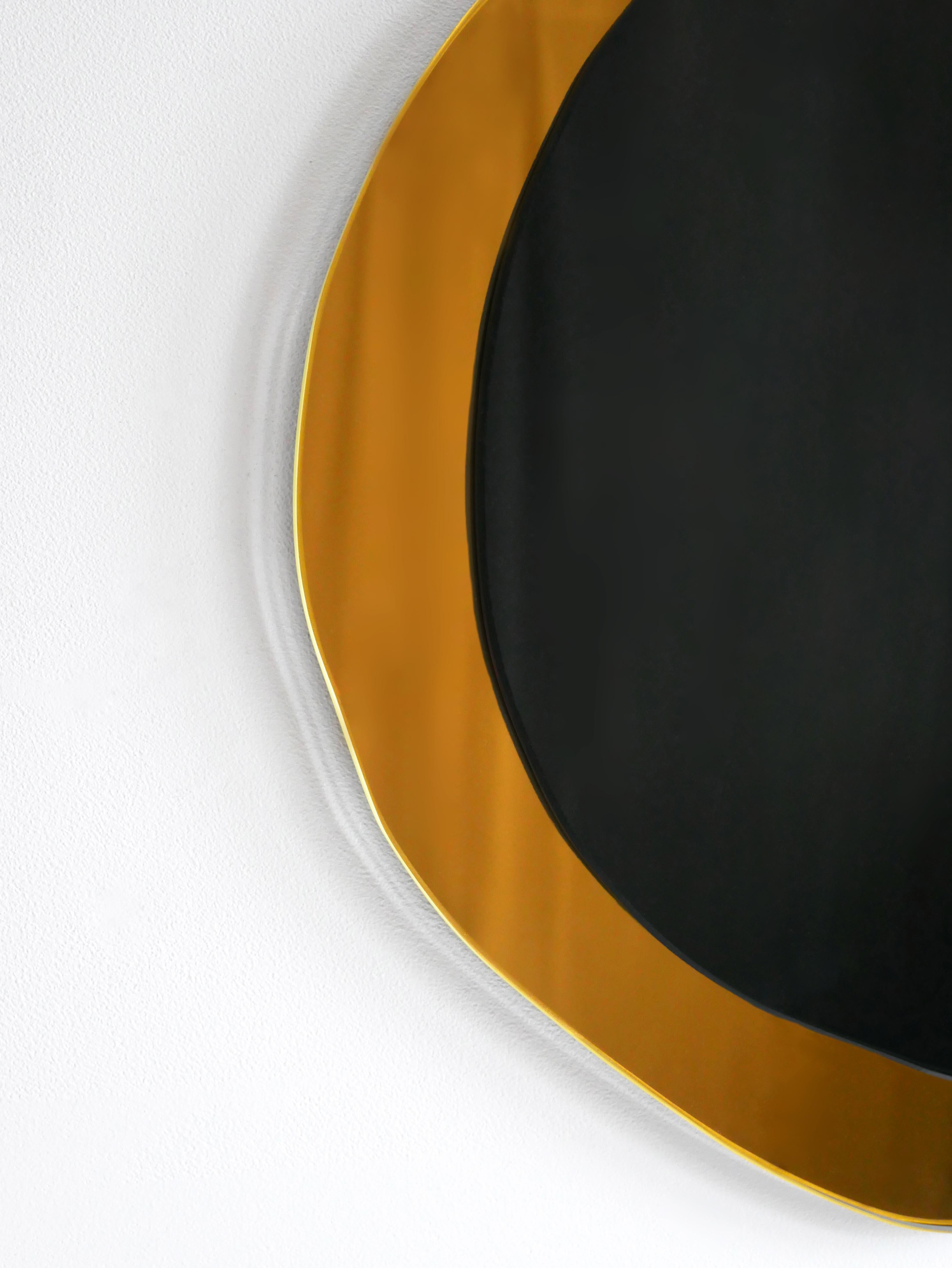 Dark Eclipse small hand-sculpted mirror, Laurene Guarneri
Limited edition.
Handmade.
Materials: Gold colored mirror, dark colored mirror.
Dimensions: 40 x 40 cm

Laurène Guarneri is a designer based in Paris.
Graduated in master's degree from