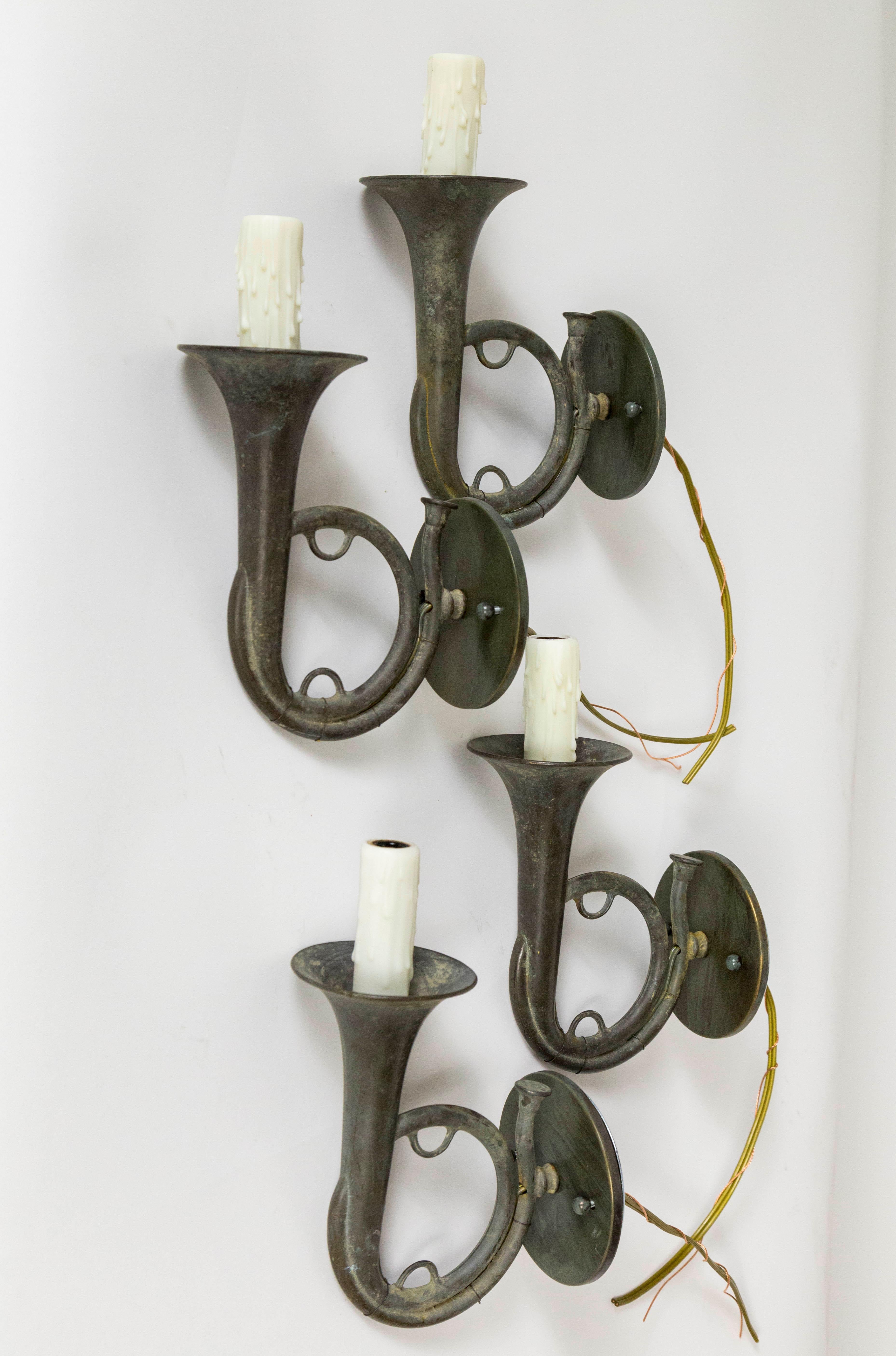 Whimsical hunting horn shaped sconces newly fashioned from parts of a 1920s American chandelier. They are made of brass, tinted in dark gray finish; with ivory colored, polyresin candle covers. We have two pairs, price listed is for one pair. 10