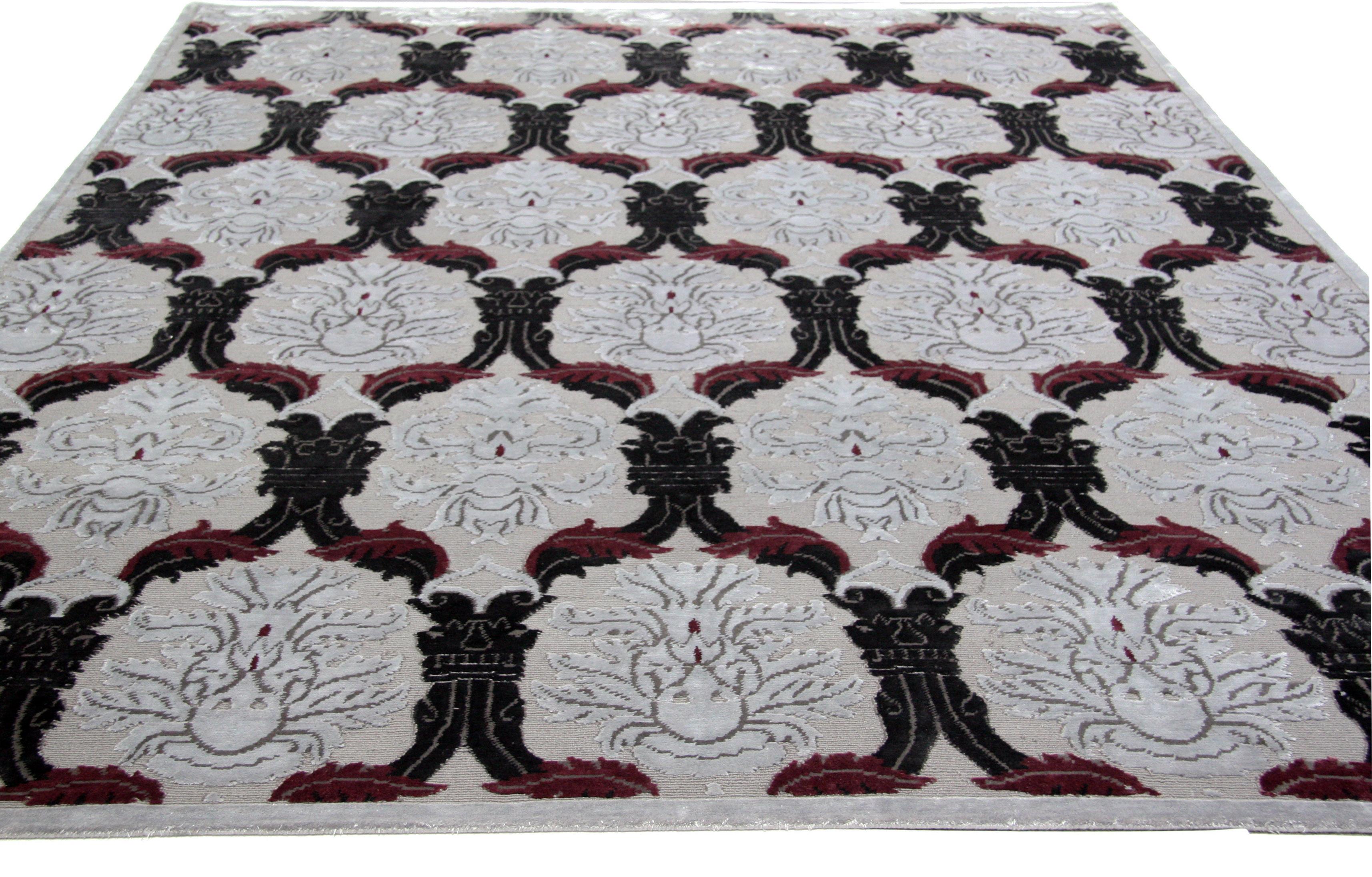 Shake up traditional room roles by bringing pattern from the walls to the floor with this damask-look wool area rug. Dark gray with black, white and fuchsia elements. Hand knotted in India.

Available in 8 x 10 and 9 x 12.