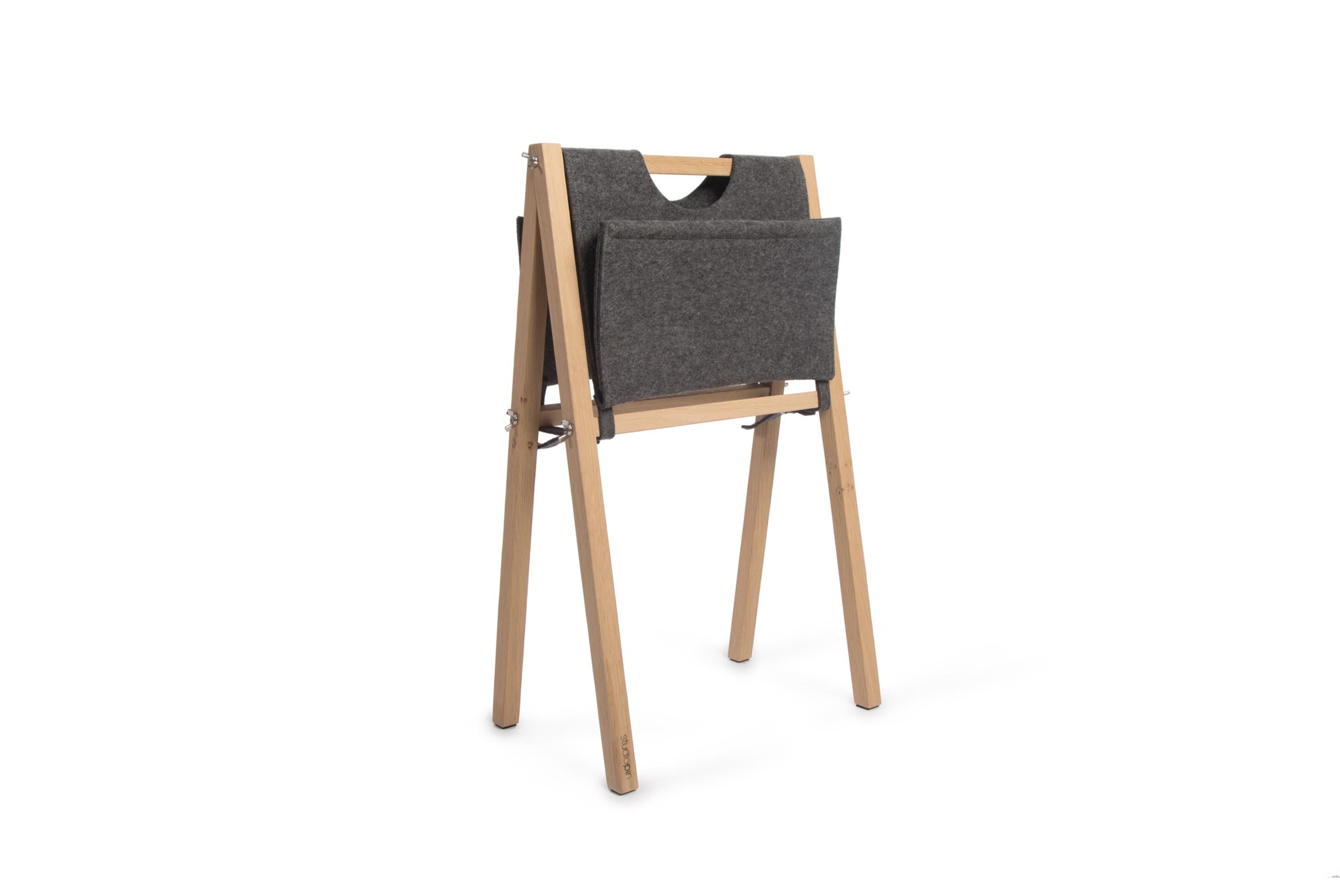 Dark gray stan magazine rack by Studio Pin
Dimensions: W 42 x D 26 x H 67.2 cm
Materials: oak, wool felt.
Weight: 2.15 Kg

Stan is a magazine rack. The oak frame perfectly matches the 3 types of bags in the colors light brown and dark grey of