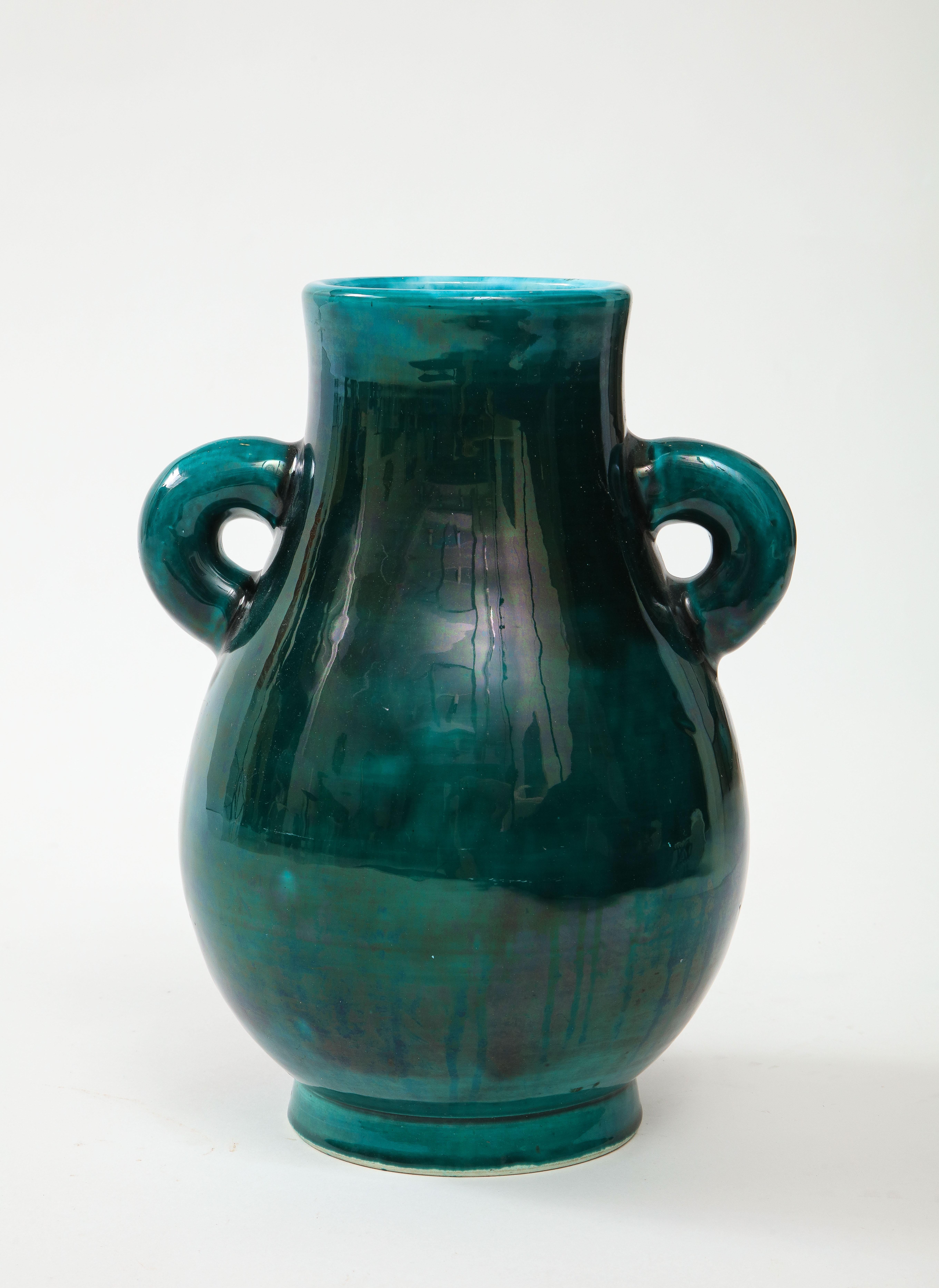 French mid century dark greenmottled glazed bouquet vase with a turquoise glazed interior and decoratve loop handles. Signed, Accolay.