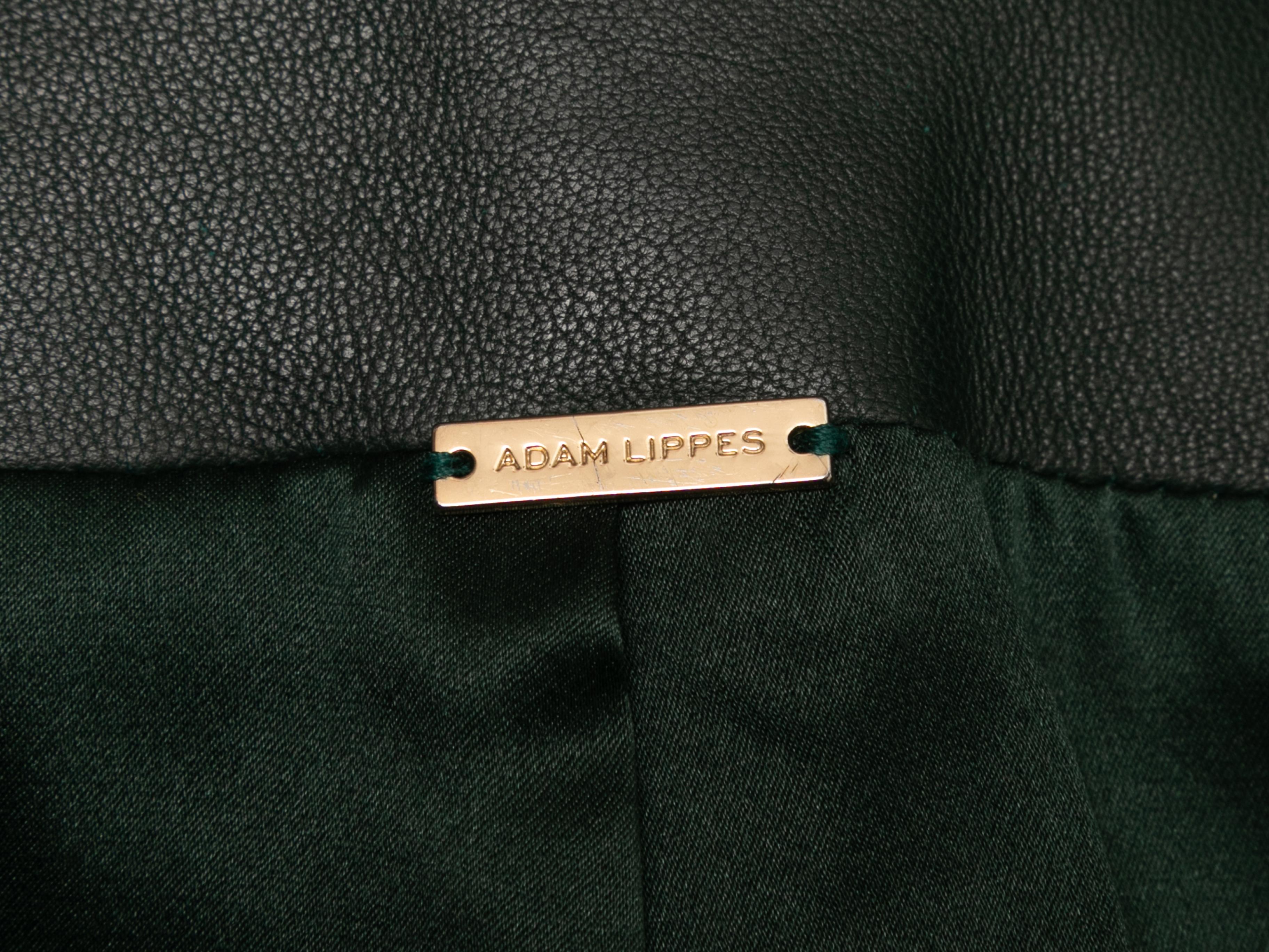 Dark green shearling moto coat by Adam Lippes. Leather trim throughout. Notched lapel. Dual zip closure hip pockets. Front zip closure. 40