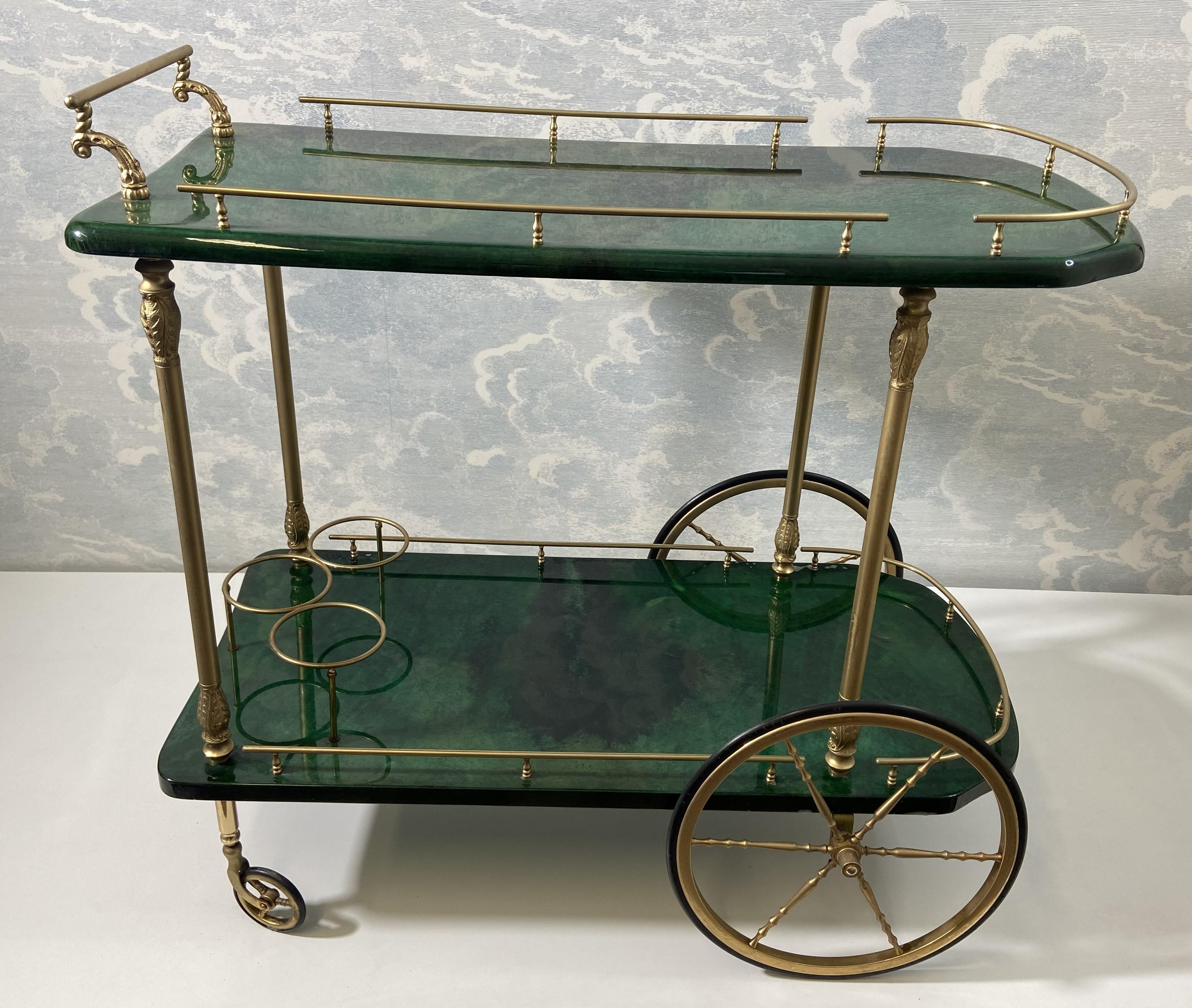 We love Aldo Tura bar carts! Check out our shop for a vast selection! This example sets itself apart from the majority of Tura's bar carts thanks to its unusual shape with inverted rounded corners at the front and a slightly curved back.

Made in