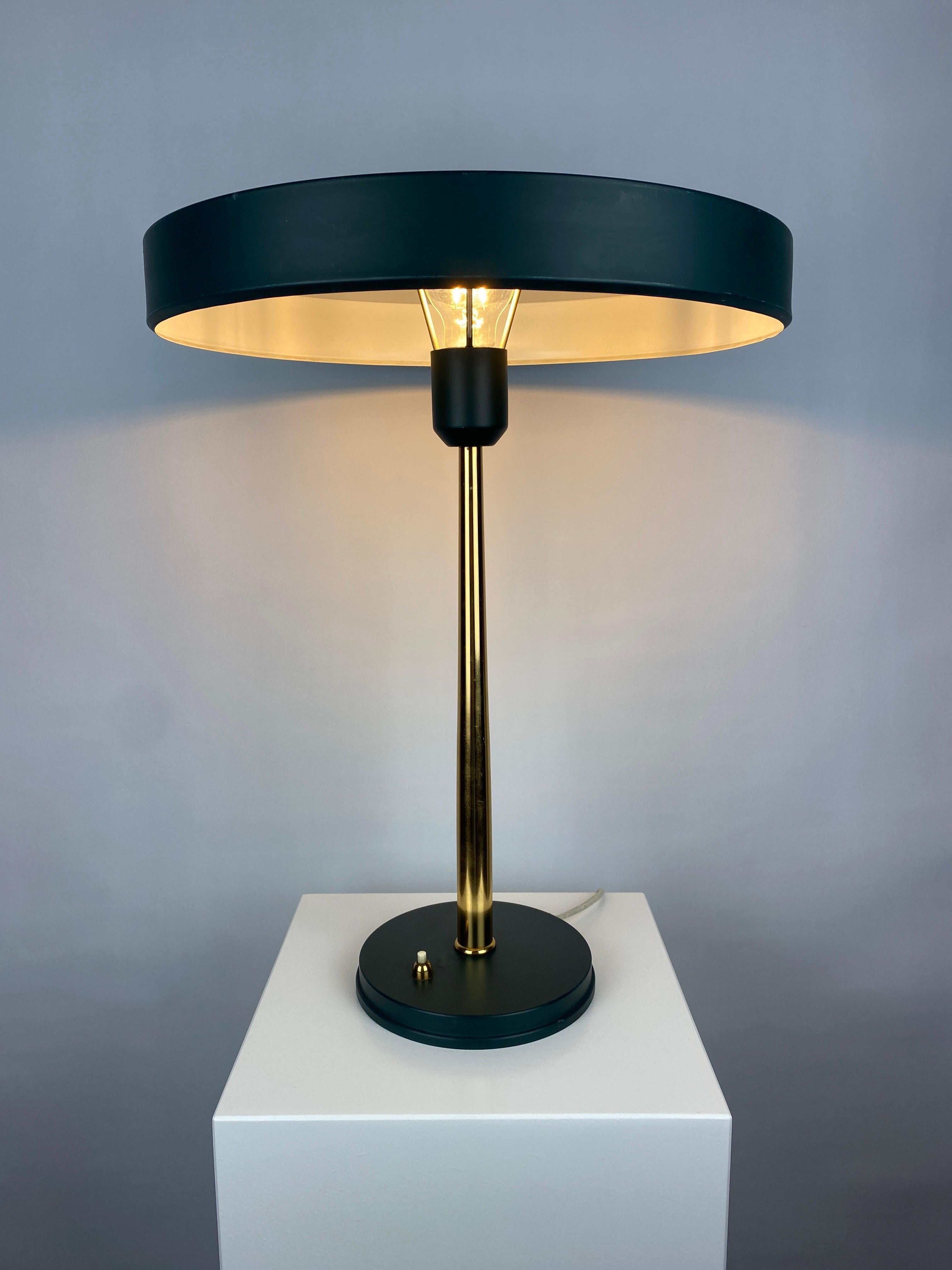 Great design by Louis 'Christiaan' Kalff for Philips called Timor 69 Desk Lamp. It is manufactured in 1970 - 1980. This version is in dark green and gold, and has a UFO lampshade with a hole in the middle for ahead mirror