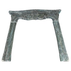 Dark green colored concrete mantle fireplace, with carved scrolls, Italy