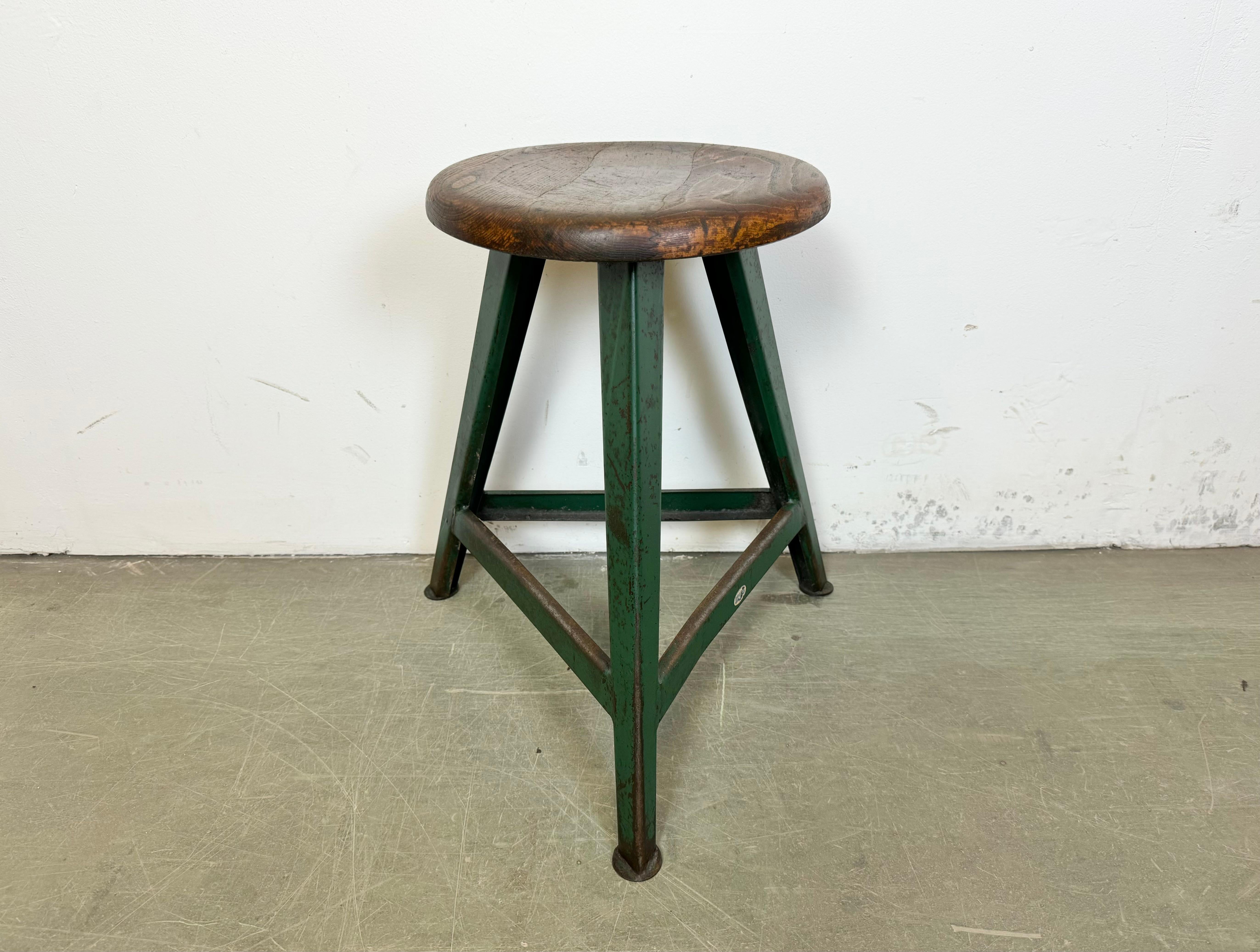 Vintage Industrial factory stool made by Drupol in former Czechoslovakia during the 1960s It features a wooden seat and a green metal frame. The weight of the stool is 3,8 kg.The diameter of the seat is 31 cm.