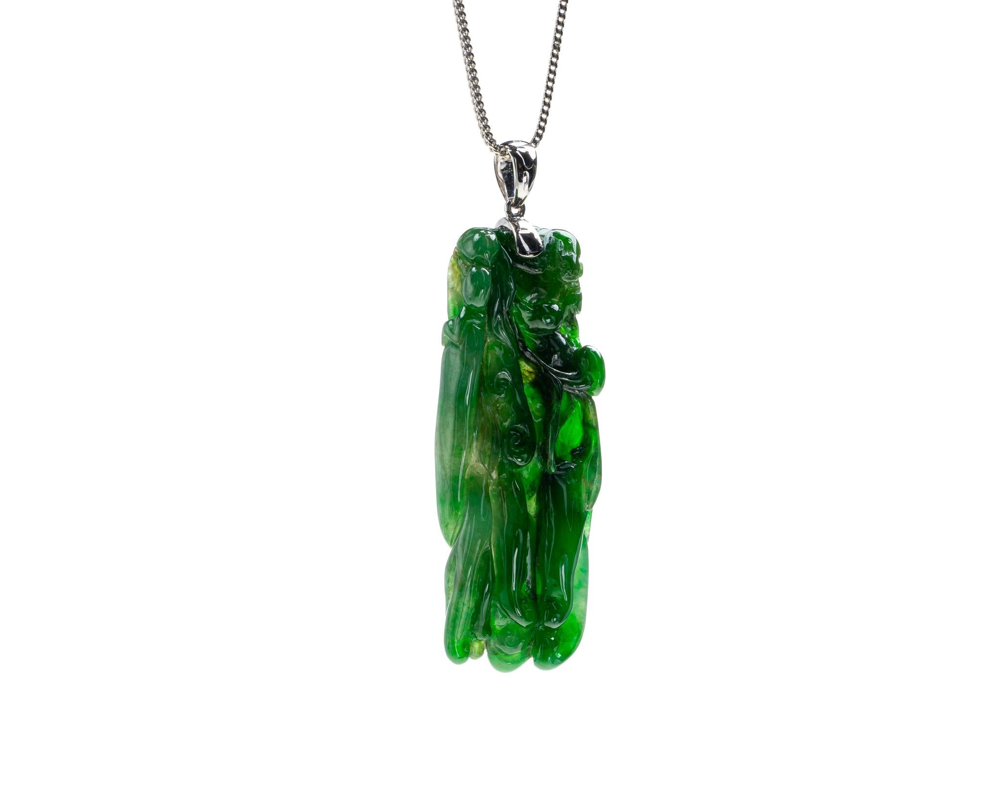 This is an all natural, untreated jadeite jade carved buddha hand pendant set on an 18K white gold  The carved buddha hand symbolizes happiness, longevity and good fortune. 

It measures 1.85 inches (47mm ) x 0.73 inches (18.7 mm) with thickness of