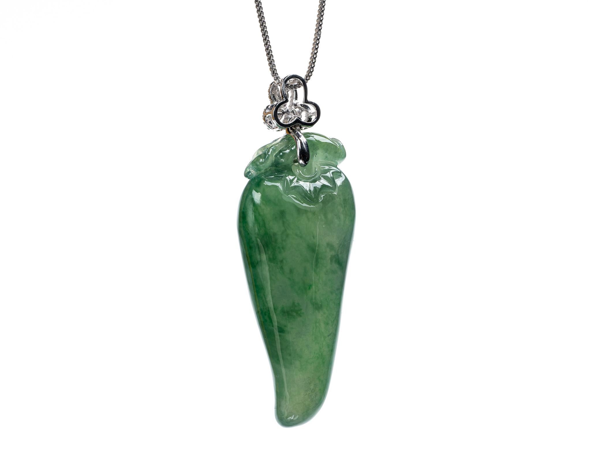 This is an all natural, untreated jadeite jade carved chili pepper pendant set on an 18K white gold and diamond bail.  The carved chili pepper symbolizes good luck and prosperity.   

It measures 0.88 inches (22.5 mm) x 2.45 inches (62.2 mm) with