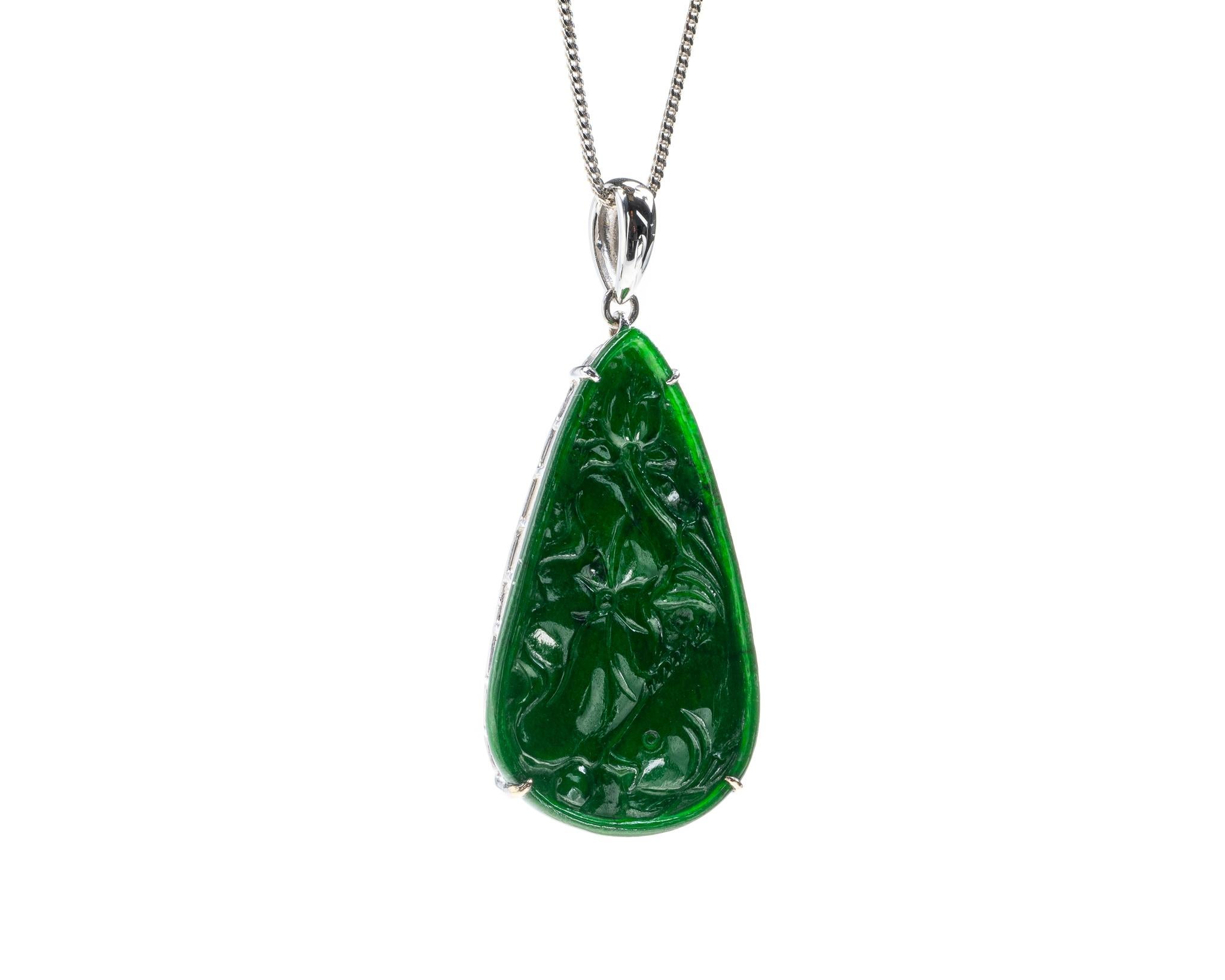 This is an all natural, untreated jadeite jade carved lotus leaf with goldfish pendant set on an 18K white gold bail.  The carved lotus leaf and goldfish together symbolizes harmony, wealth and prosperity.

It measures 1.51 inches (38.4 mm) x 0.88