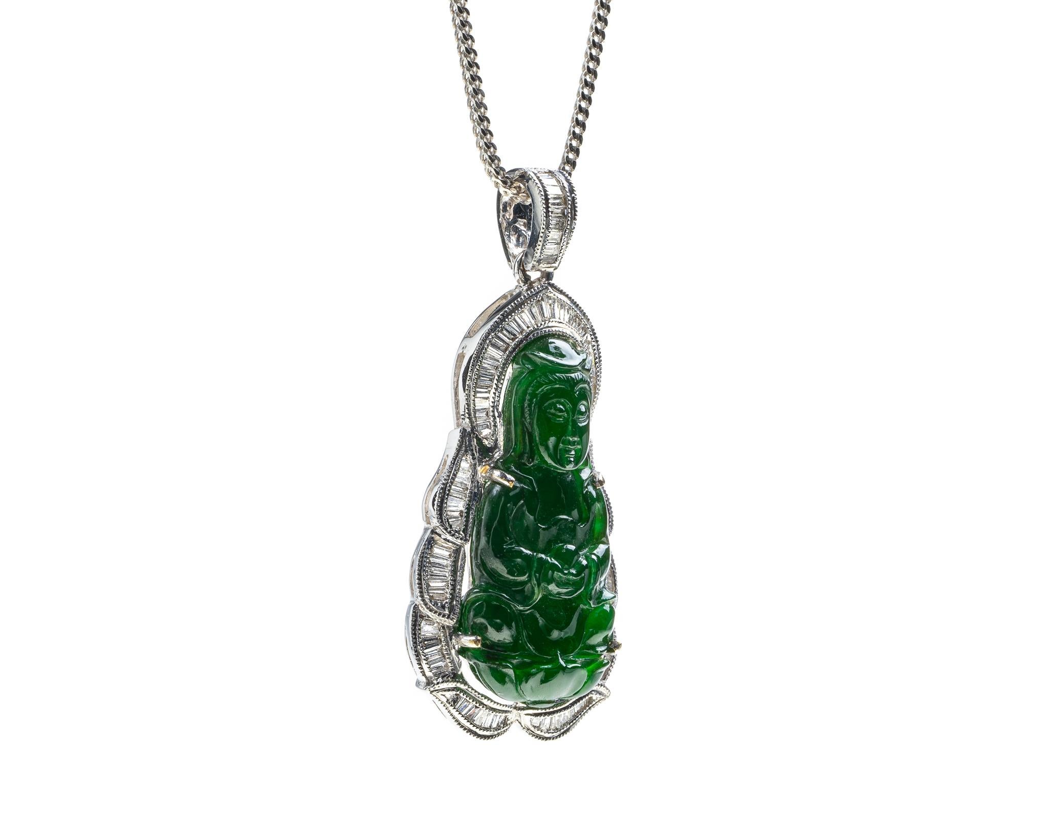 This is an all natural, untreated green jadeite jade carved Quan Yin god pendant set on an 18K white gold bail.  The carved Quan Yin god symbolizes compassion and protection. 

It measures 1.40  inches (35.6 mm) x 0.64 inches (16.5 mm) with
