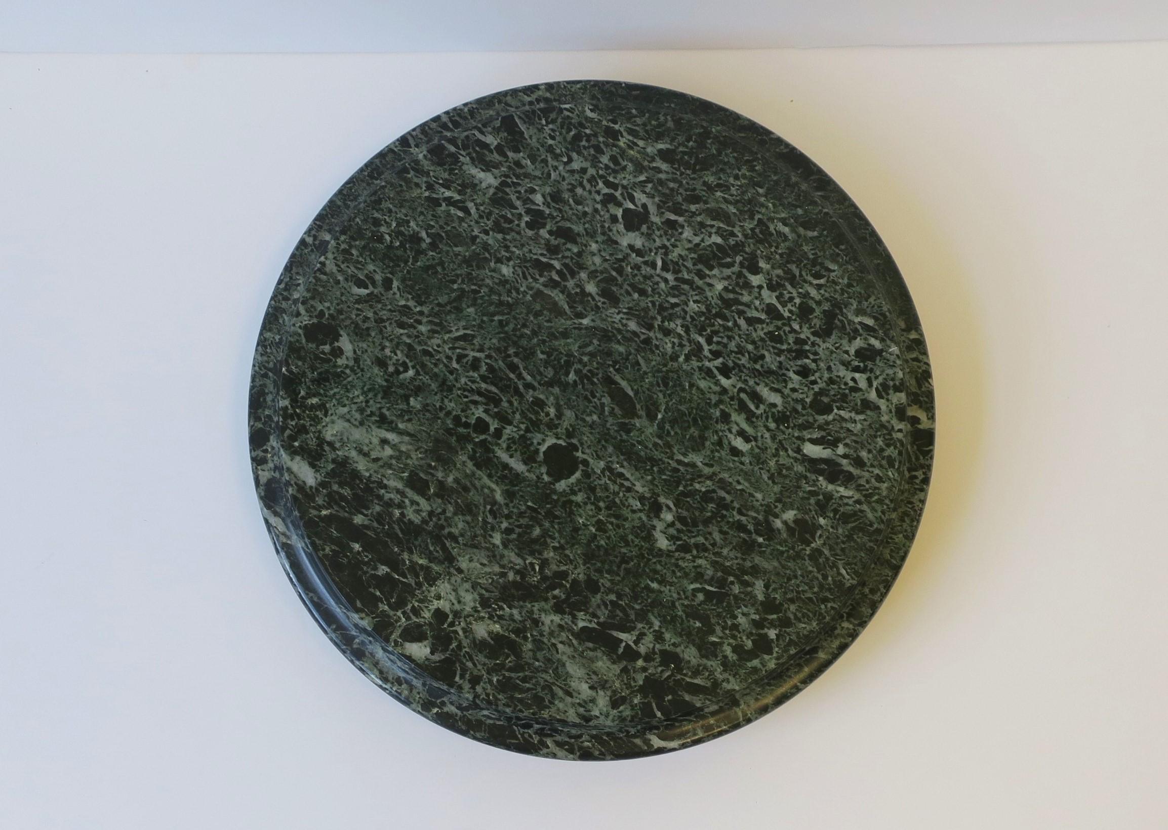 A substantial dark green marble Lazy Susan, circa late-20th century. Marble is dark green with white veining. A great piece for a kitchen, bar, entertaining area, etc. Use it to hold salt/pepper, condiments, or use to hold small appetizers,