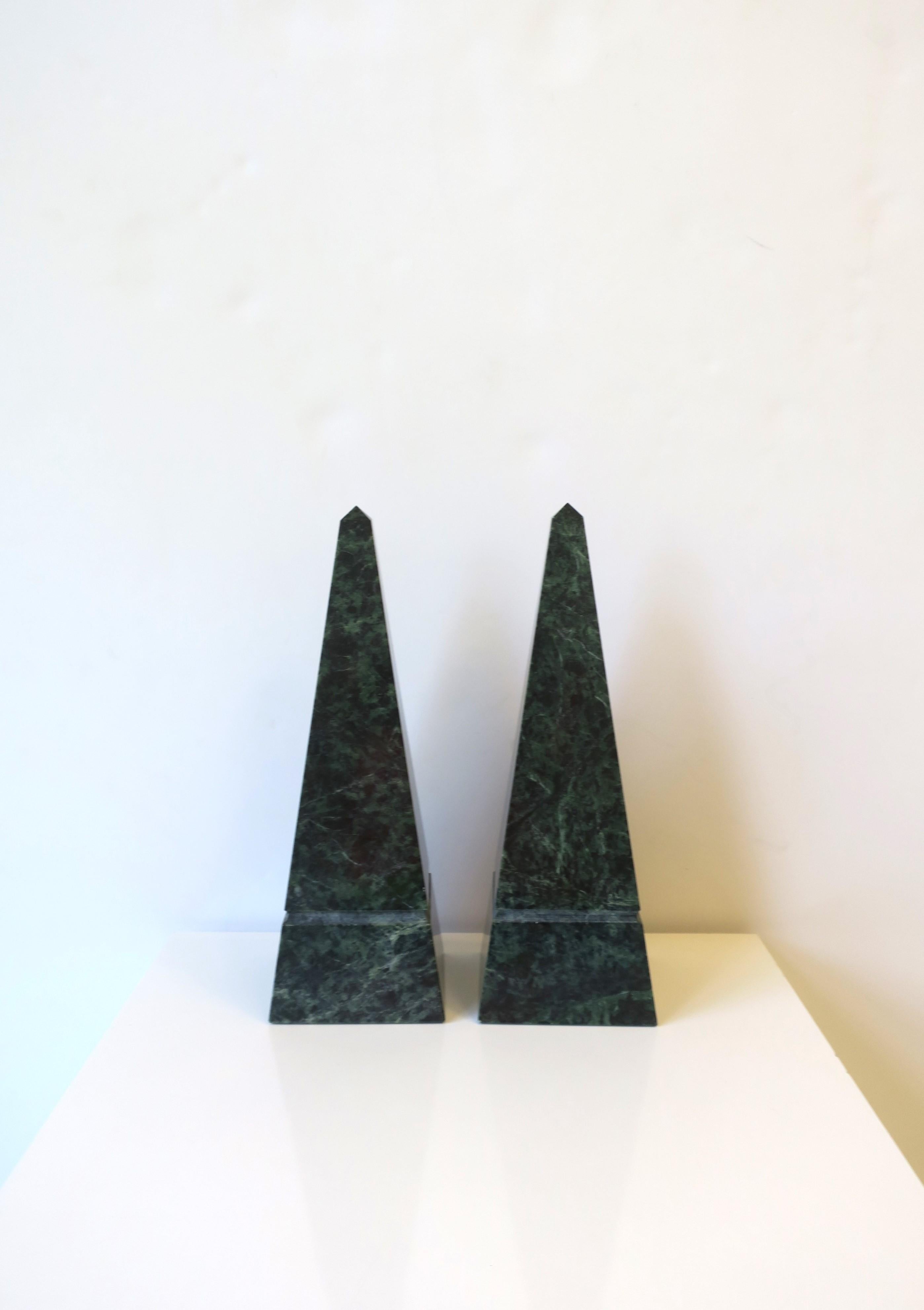 A substantial pair of dark green marble Obelisk sculptures in the modern style, circa late-20th century. Pair/set are dark green marble with black veining, some minor traces of white too. A great set for a mantle, cocktail table, bookshelf, office,