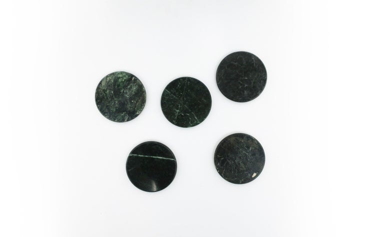 A vintage set of five (5) modern/Postmodern style round dark green marble stone coasters for drinks, cocktails, champagne, etc. Coasters are dark green with traces of white, soft edge, polished smooth. A great addition to any bar, bar cart, or
