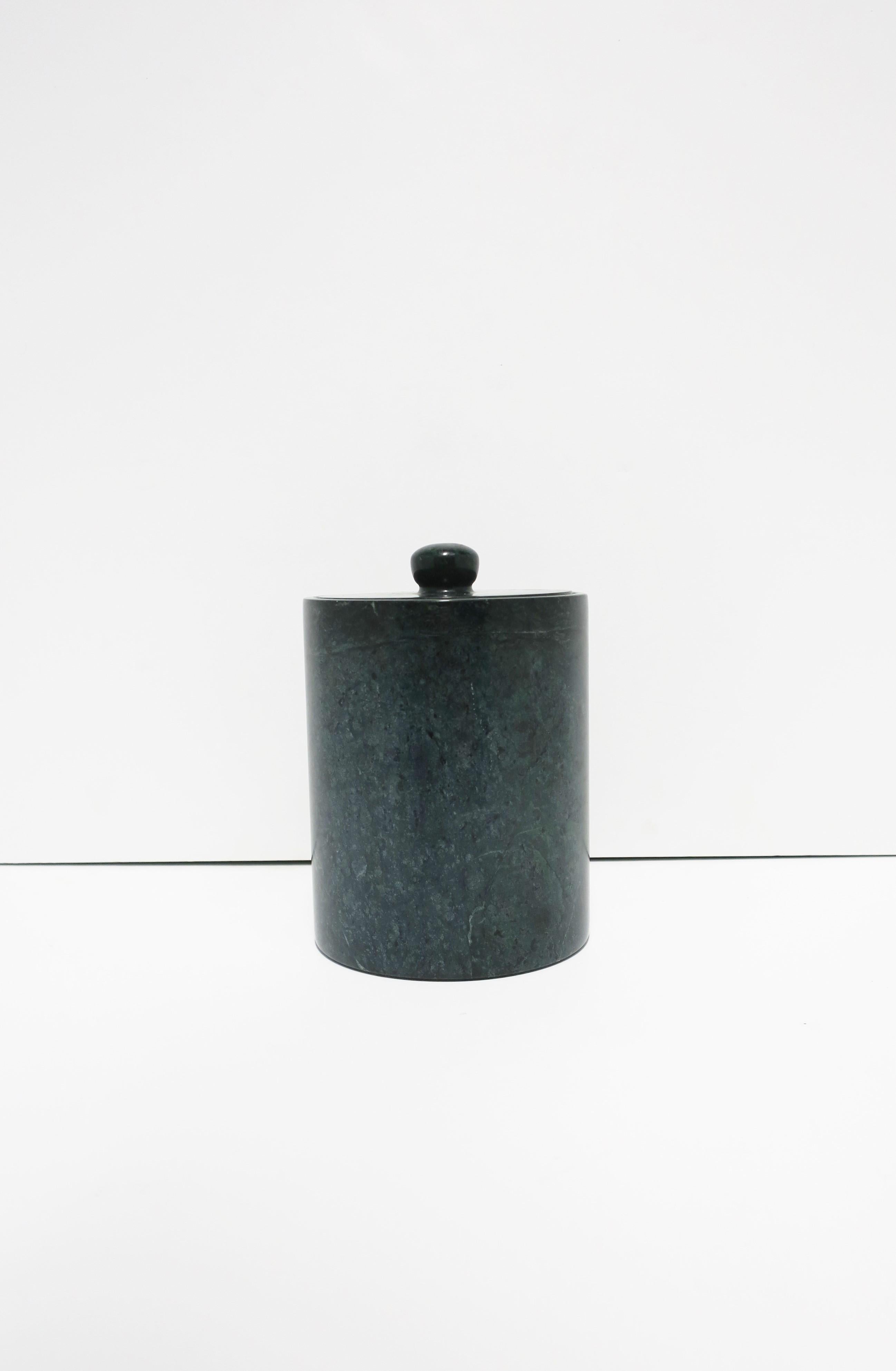 A substantial dark green marble vessel box with lid, circa late-20th century. Piece is dark and medium green hues with traces of white as shown. This round cylindrical box has an internal teak wood separator, which is removable (as shown), finished