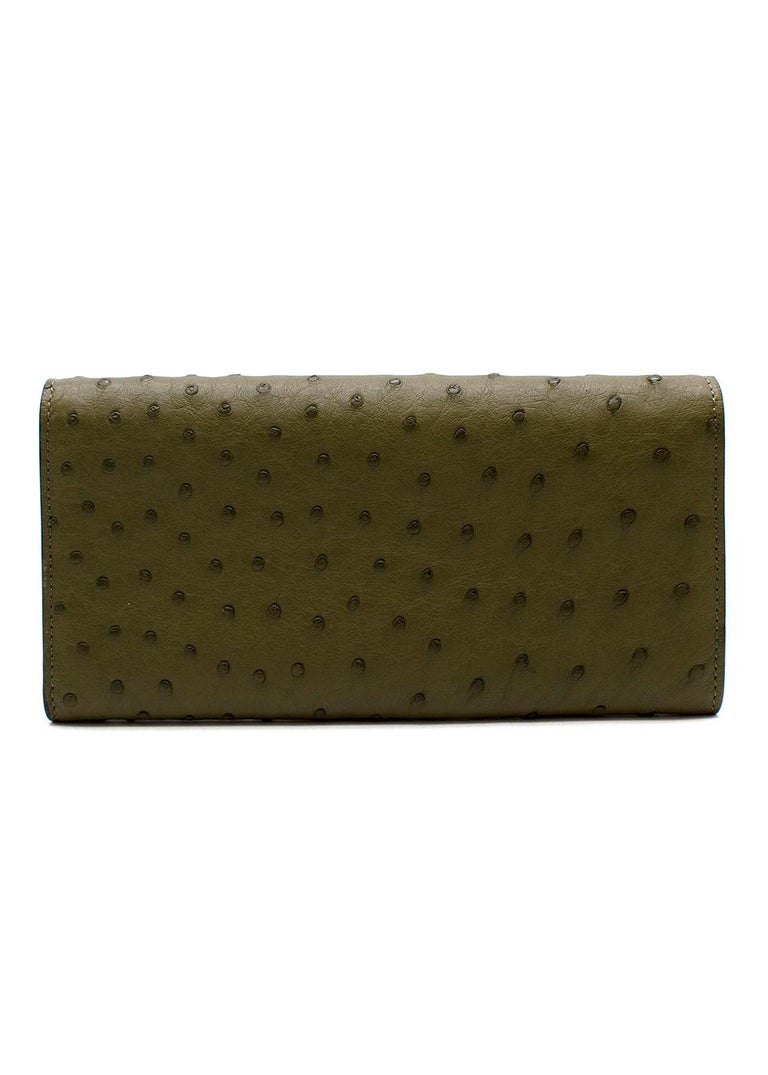 Fendi dark green ostrich flap long wallet

- Deep olive green hue, featuring the natural texture of the ostrich hide
- Flap opening with gold-tone metal F logo clasp
- Wallet interior with eight card holder slots and zip pocket 
- Detachable gold