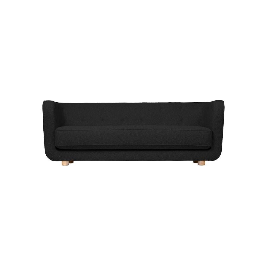 Dark grey and natural Oak Hallingdal Vilhelm sofa by Lassen
Dimensions: W 217 x D 88 x H 80 cm 
Materials: Textile, Oak.

Vilhelm is a beautiful padded 3-seater sofa designed by Flemming Lassen in 1935. A sofa must be able to function in several