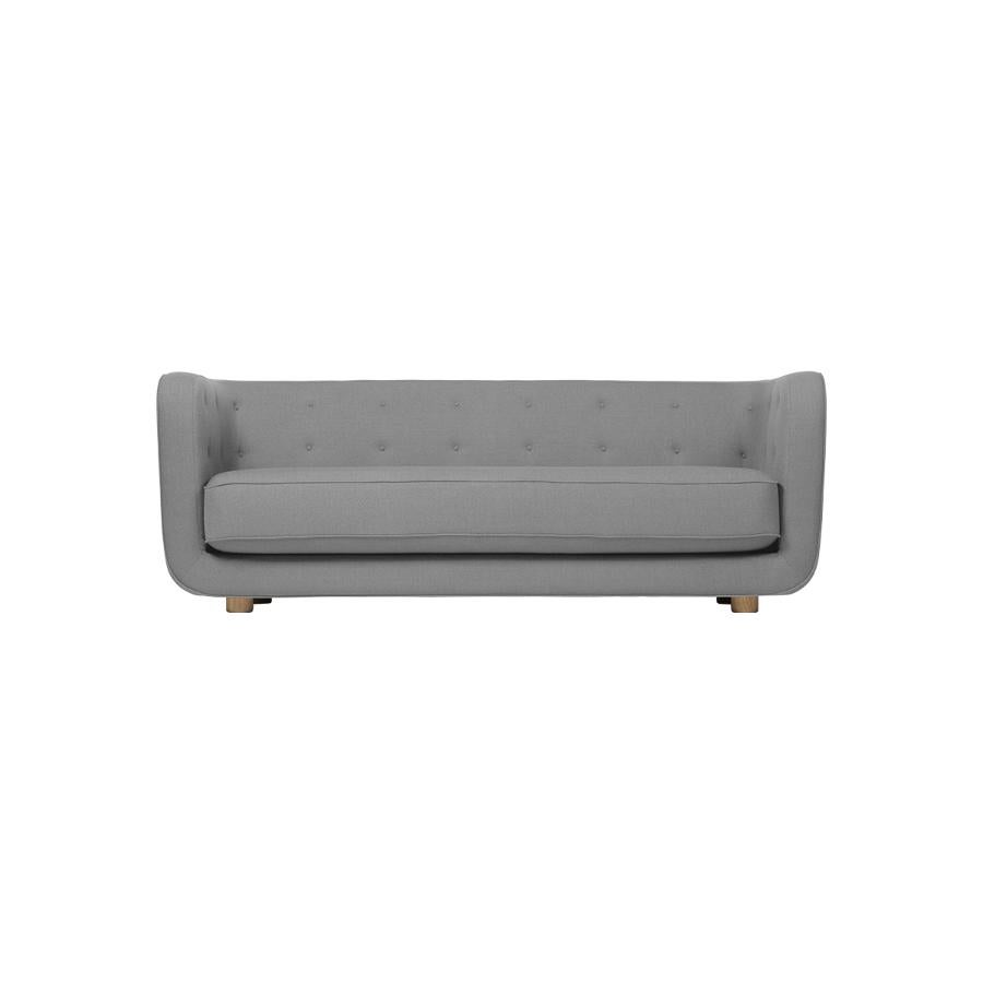 Dark grey and smoked oak Raf Simons Vidar 3 Vilhelm sofa by Lassen
Dimensions: W 217 x D 88 x H 80 cm 
Materials: textile, oak.

Vilhelm is a beautiful padded three-seater sofa designed by Flemming Lassen in 1935. A sofa must be able to function