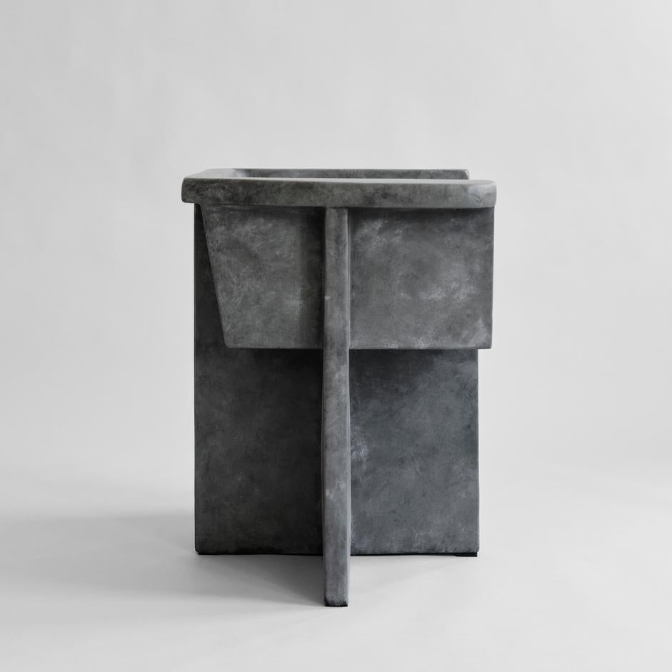 Dark grey brutus dining chair by 101 Copenhagen
Designed by Kristian Sofus Hansen & Tommy Hyldahl
Dimensions: L 68 / W 50 /H 68 cm
Seat height: 44cm / Seat depth: 37 cm
Backrest height: 24 cm

Materials: metal: fiber concrete

Inspired by