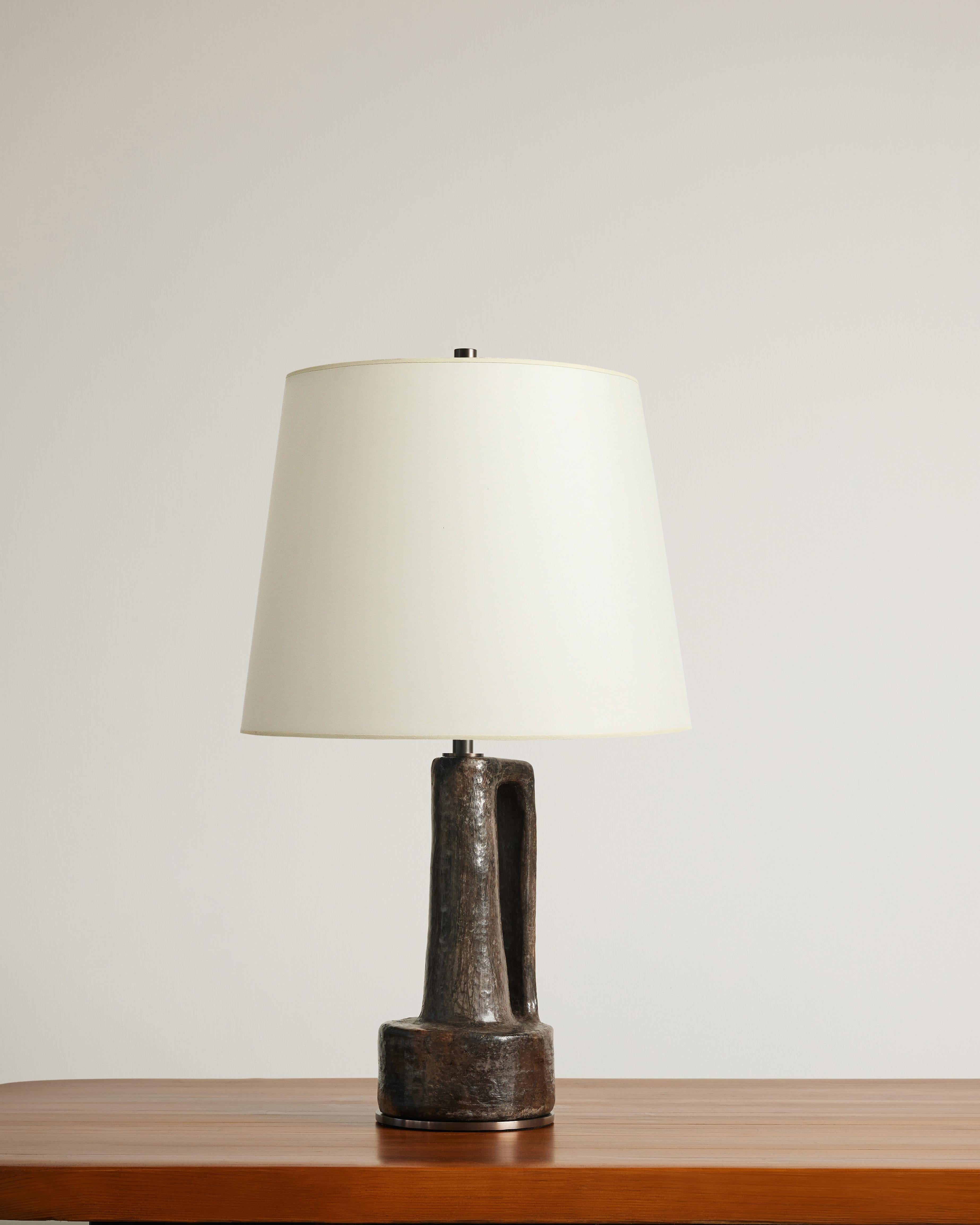 Glazed ceramic table lamp with patinated steel base. Newly rewired with an 8 ft. black twisted silk cord, on/off on the cord, dimmer at neck and adjustable harp.