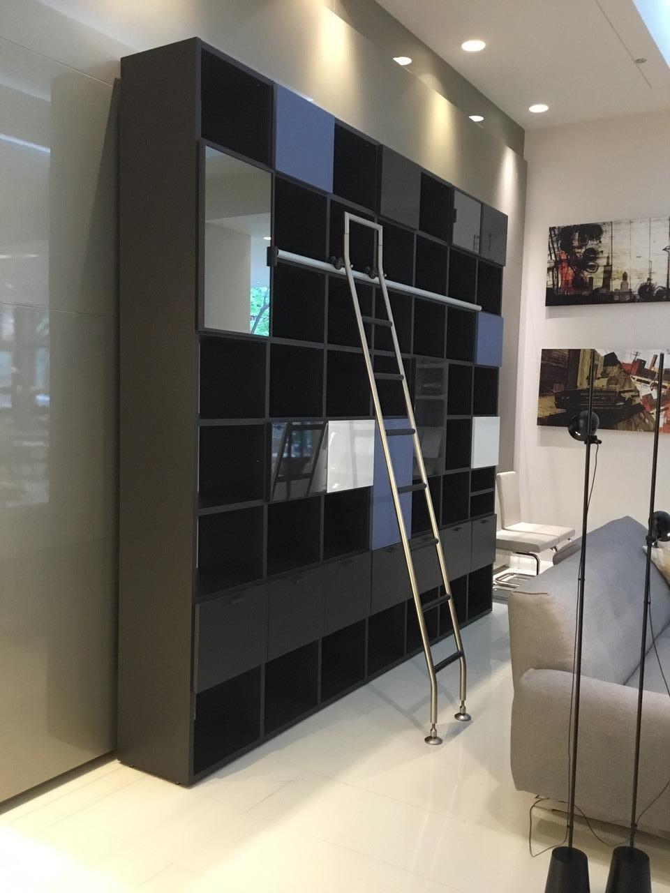 Designed by Antonia Citterio for Tisettanta

Contemporary bookcase with shelves in matt dark grey lacquer with a mix of drawers and hinged door fronts in matt and glossy white and blue lacquer and mirror finish. 

Bookcase includes 7 drawers, 13