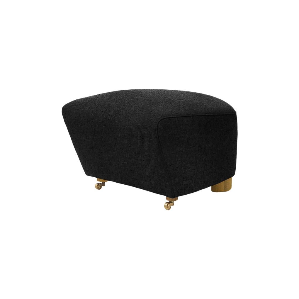 Dark grey natural oak Hallingdal the tired man footstool by Lassen
Dimensions: W 55 x D 53 x H 36 cm 
Materials: Textile

Flemming Lassen designed the overstuffed easy chair, The Tired Man, for The Copenhagen Cabinetmakers’ Guild Competition in