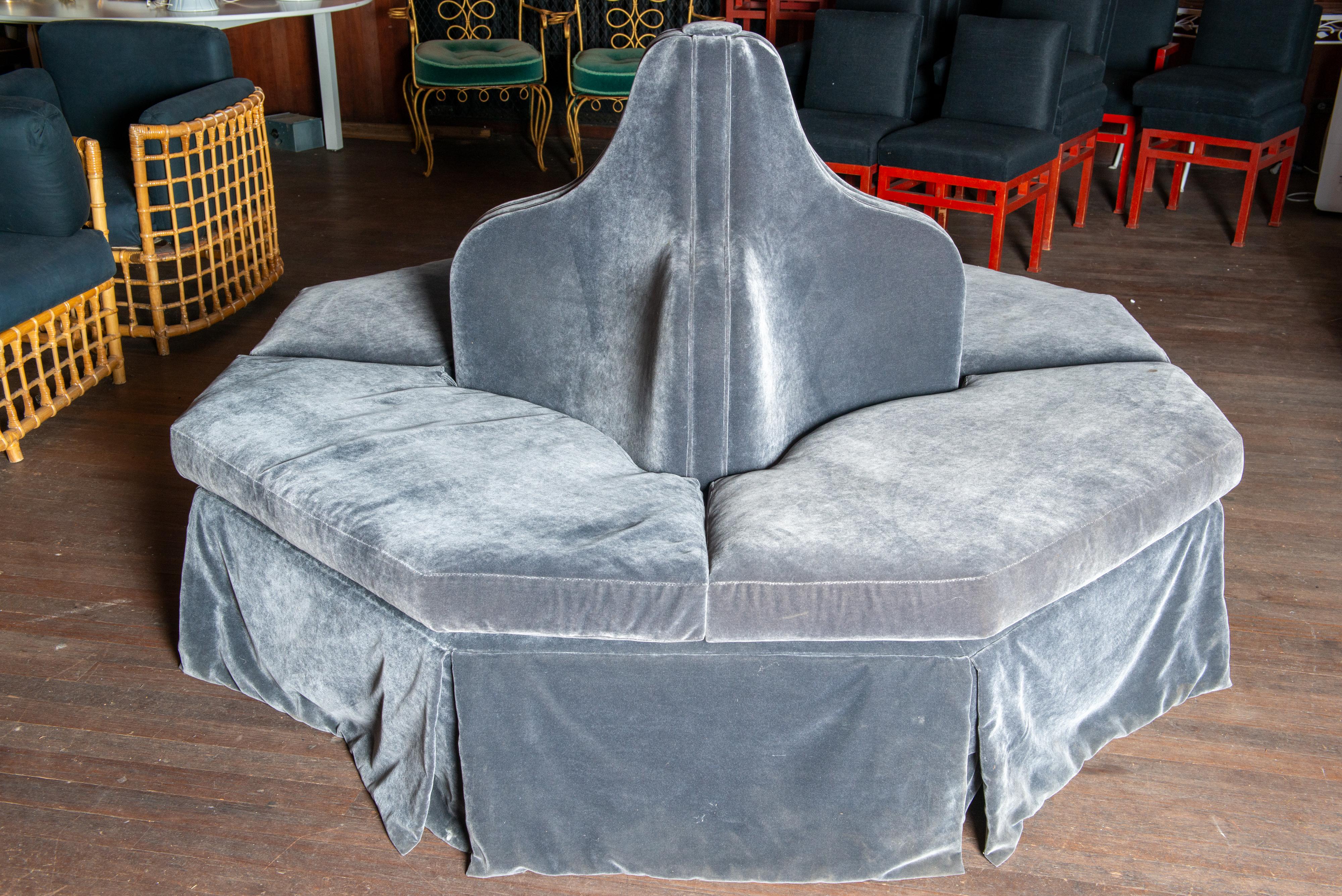 A stunning dark grey velvet four section custom made bourne. The base is hexagonal in shape with a luxurious inverted pleated flat valance. Four shaped and curved back supports create a dramatic sculptural profile.
This piece is made by Century