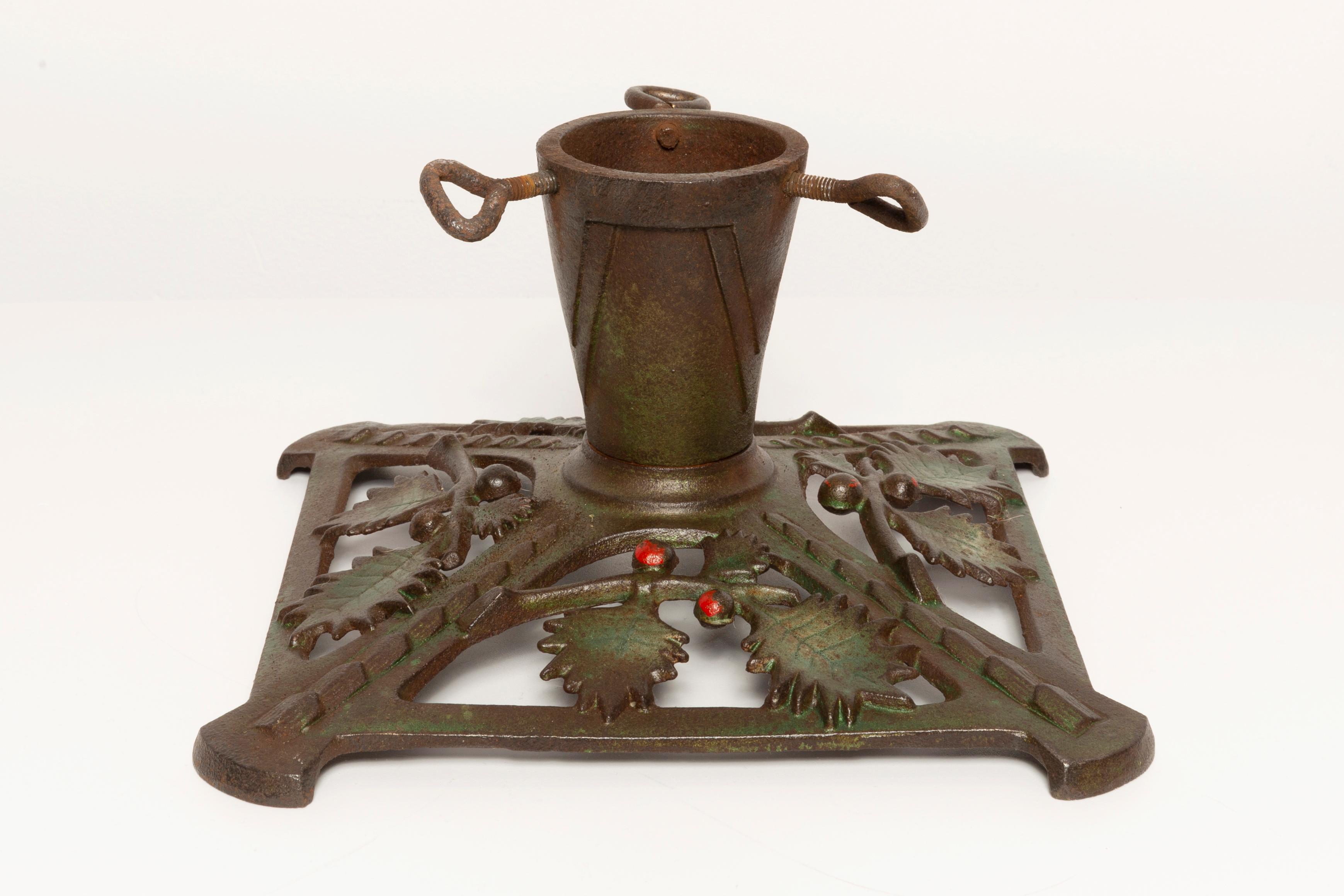 This early 20th century, cast iron Christmas tree stand is especially crafted for small Christmas trees. It is perfectly Art Deco in shape and it is ideal for displaying a Christmas tree in a shop window, on a table or on the floor, but made for